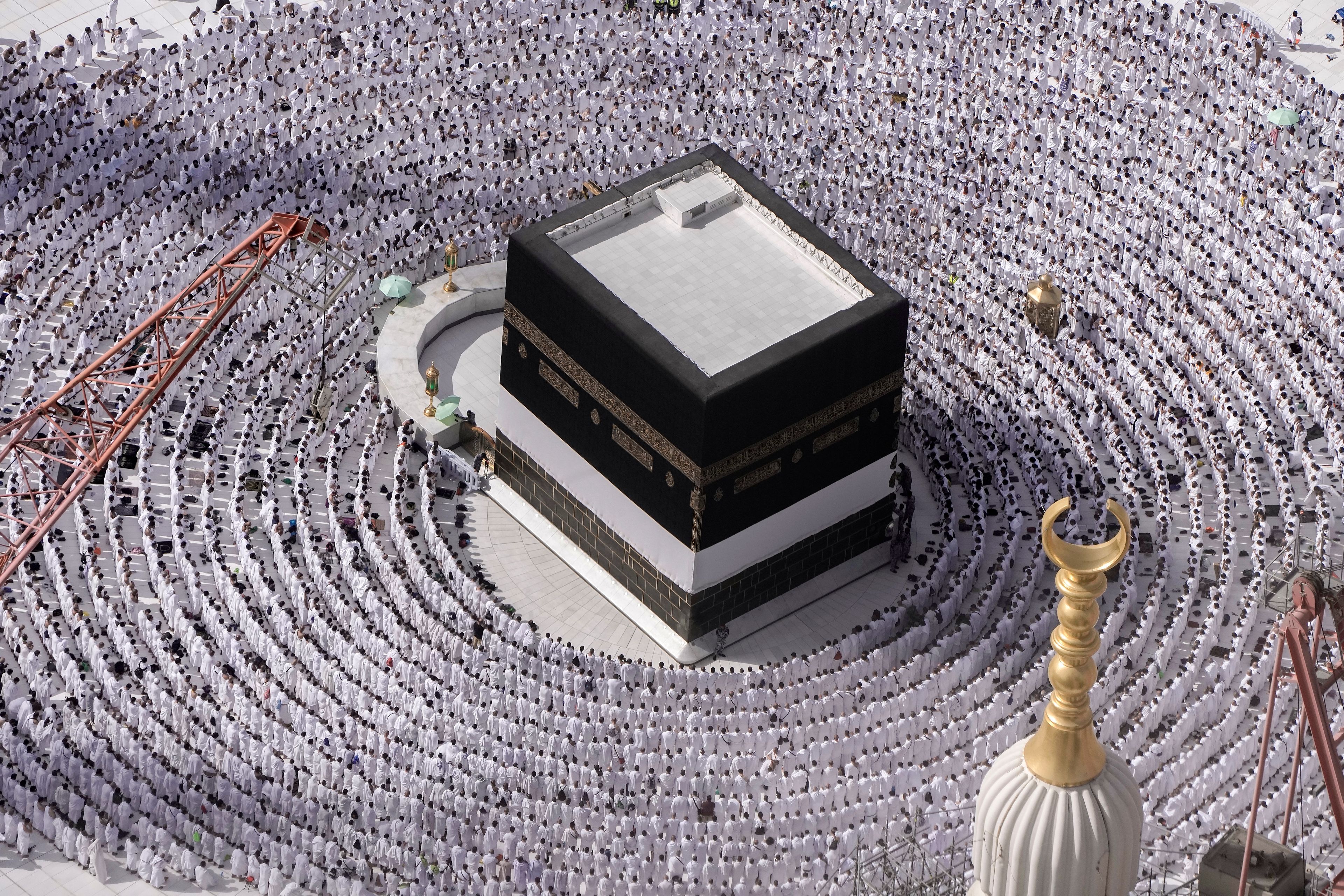 FILE - Muslim pilgrims pray around the Kaaba, the cubic building at the Grand Mosque, during the annual Hajj pilgrimage in Mecca, Saudi Arabia, on June 25, 2023. Muslims do not worship the Kaaba, a cube-shaped structure that they consider the metaphorical house of God; it’s the focal point toward which devout Muslims face during their daily prayers from anywhere in the world.