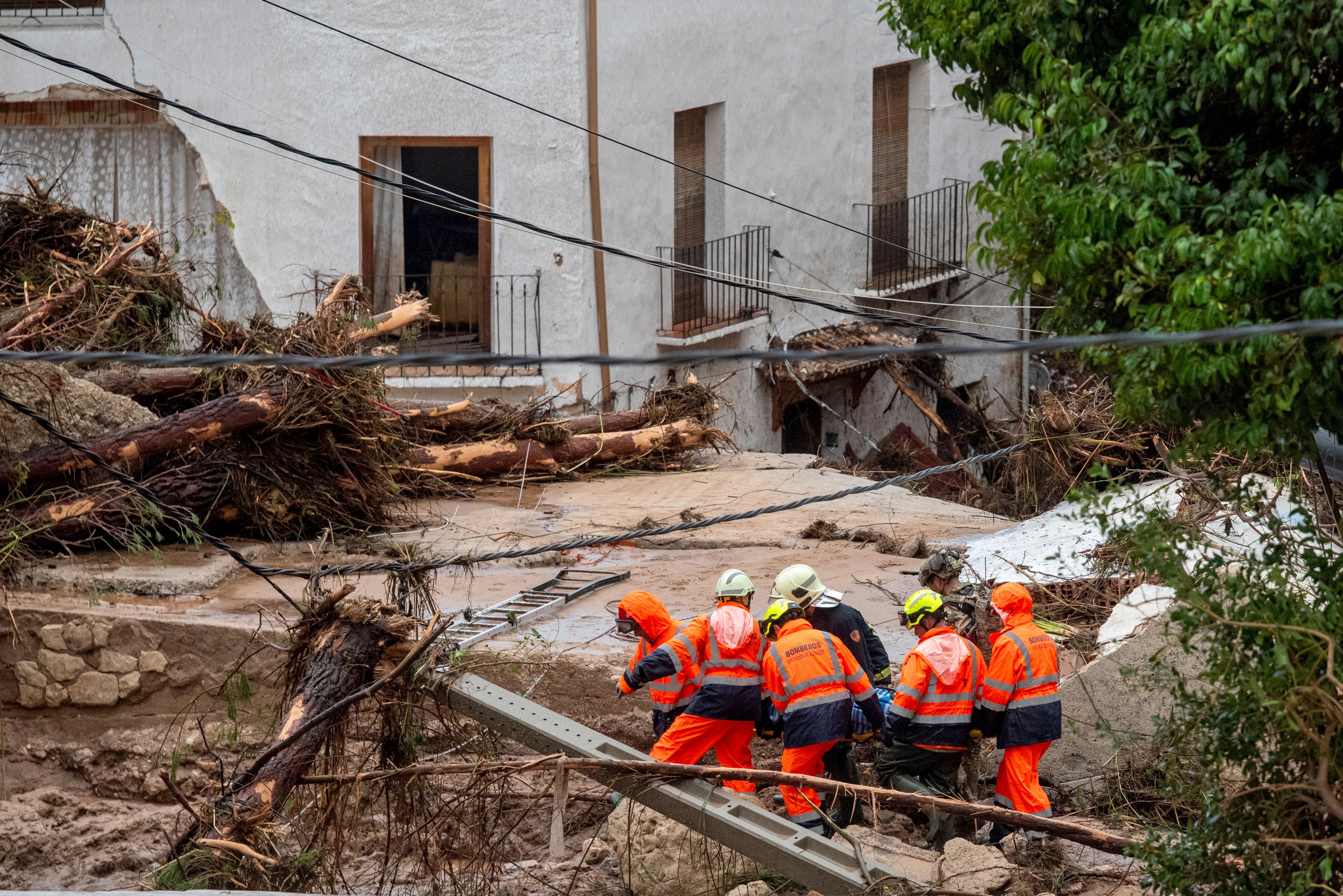 Members of emergency services carry the body of a person trapped after floods in Letur, Albacete, Tuesday, Oct. 29, 2024. (VÃ­ctor FernÃ¡ndez/Europa Press via AP)