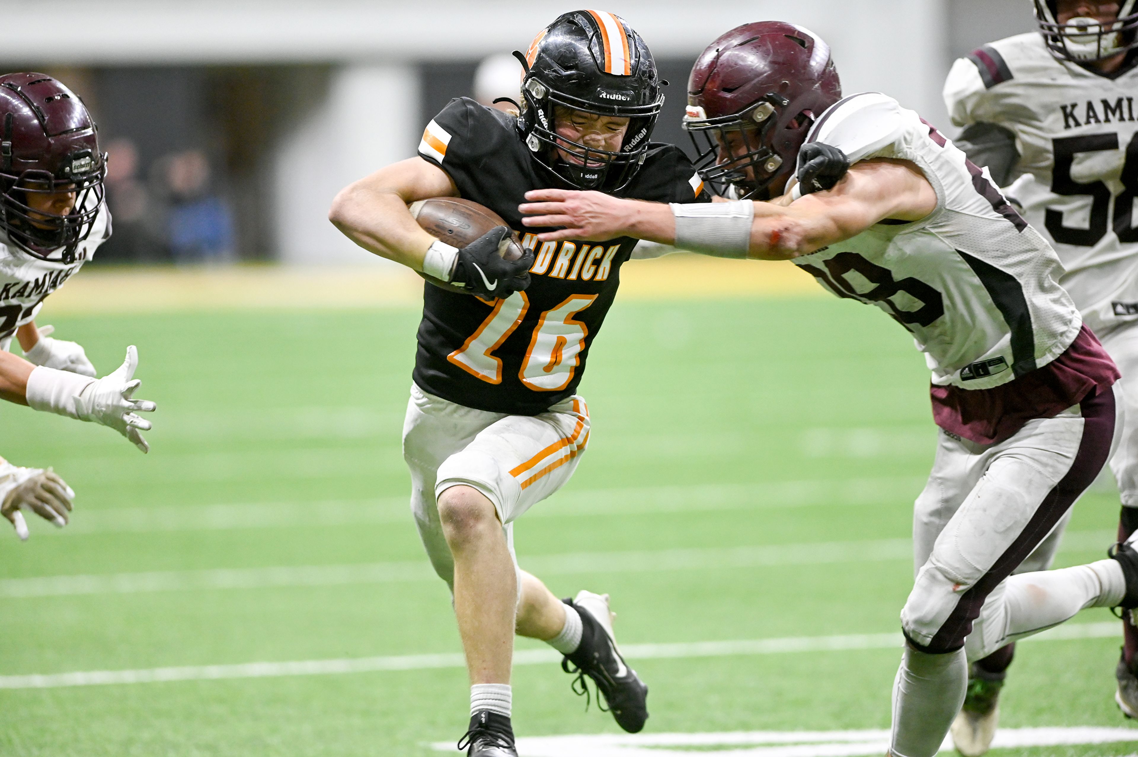 Kendrick’s Orion Stewart pushes against Kamiah’s Dave Kludt while moving down the field at an Idaho Class 2A state quarterfinal game at the P1FCU Kibbie Dome in Moscow.