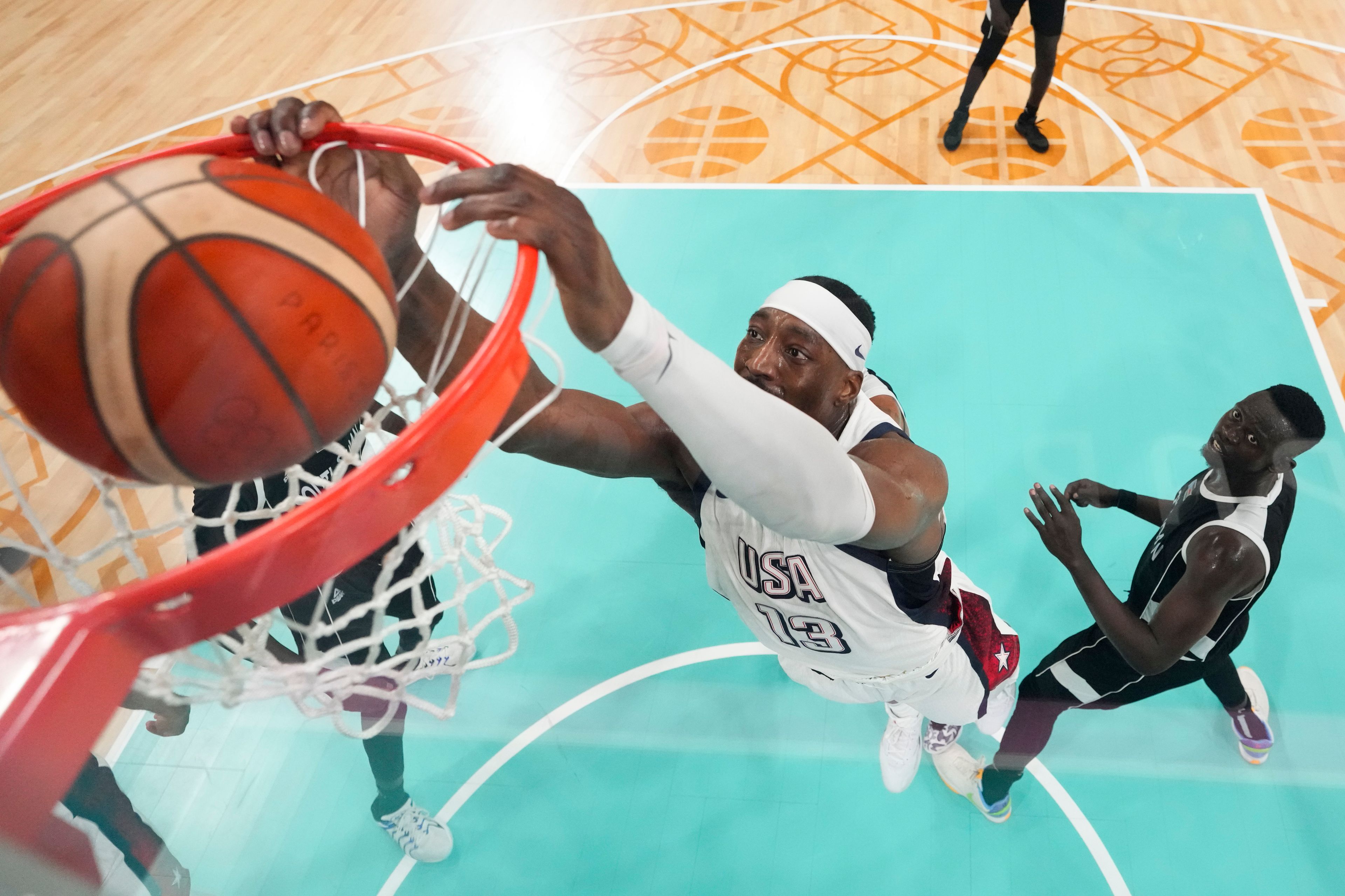 Bam Adebayo, of the United States, puts in a basket in front of Peter Jok, of South Sudan, in a men's basketball game at the 2024 Summer Olympics, Wednesday, July 31, 2024, in Villeneuve-d'Ascq, France. (AP Photo/Mark J. Terrill, Pool)