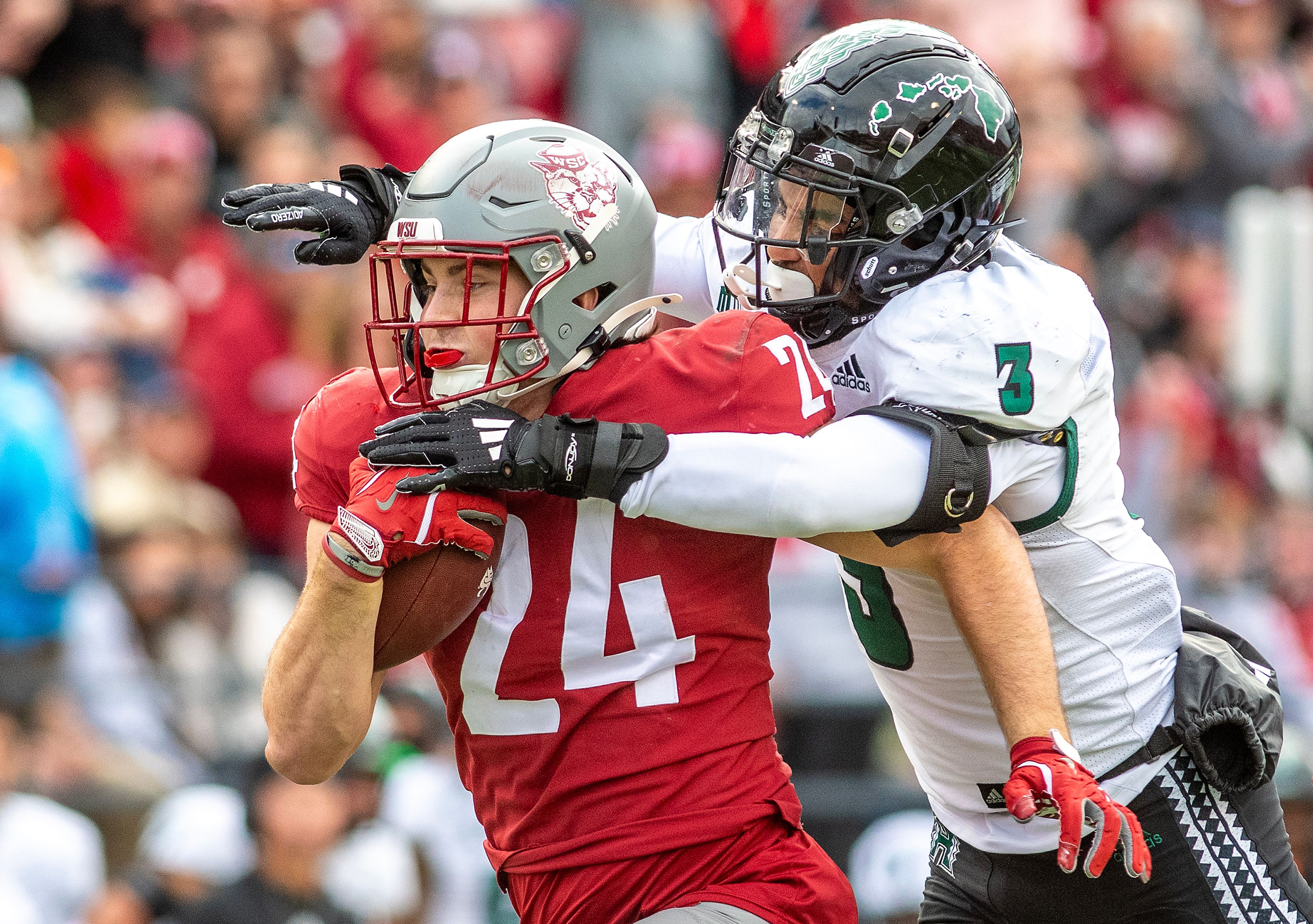 Washington State tight end Cooper Mathers  runs the ball as Hawaii linebacker Jalen Smith leaps on his back in a college football game on Saturday at Gesa Field in Pullman. WSU defeated Hawaii 42-10.,