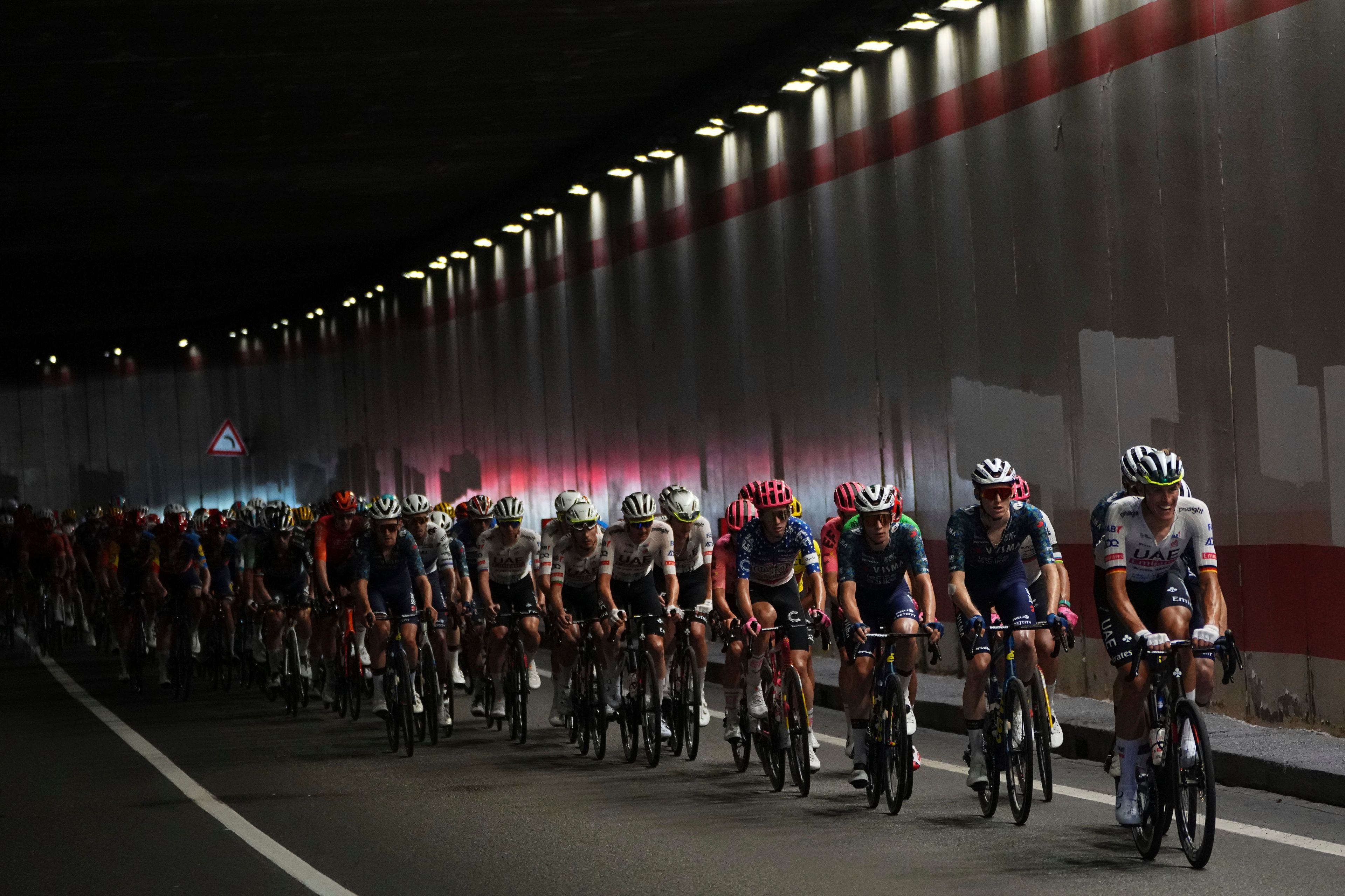 The pack rides during the fourth stage of the Tour de France cycling race over 139.6 kilometers (86.7 miles) with start in Pinerolo, Italy and finish in Valloire, France, Tuesday, July 2, 2024. (AP Photo/Daniel Cole)