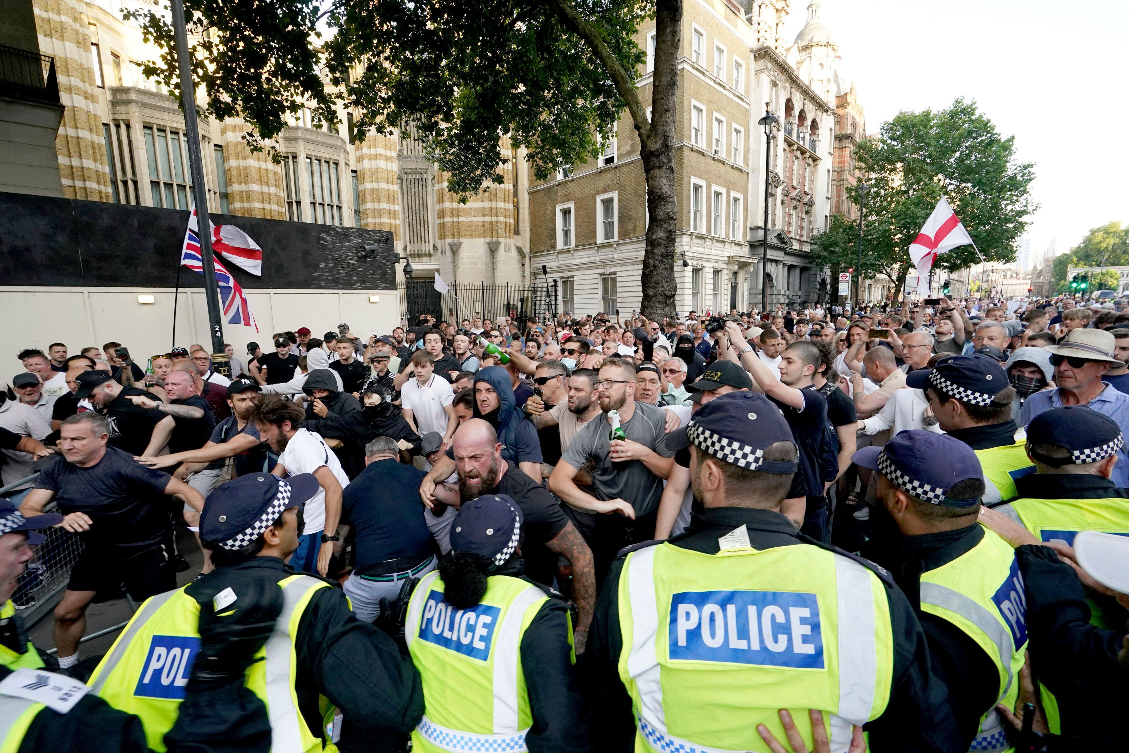 Police officers clash with protesters during a 'Enough is Enough' protest rally in Whitehall, London, Wednesday July 31, 2024 following the fatal stabbing of three children at a Taylor Swift-themed holiday club on Monday in Southport. (Jordan Pettitt/PA via AP)