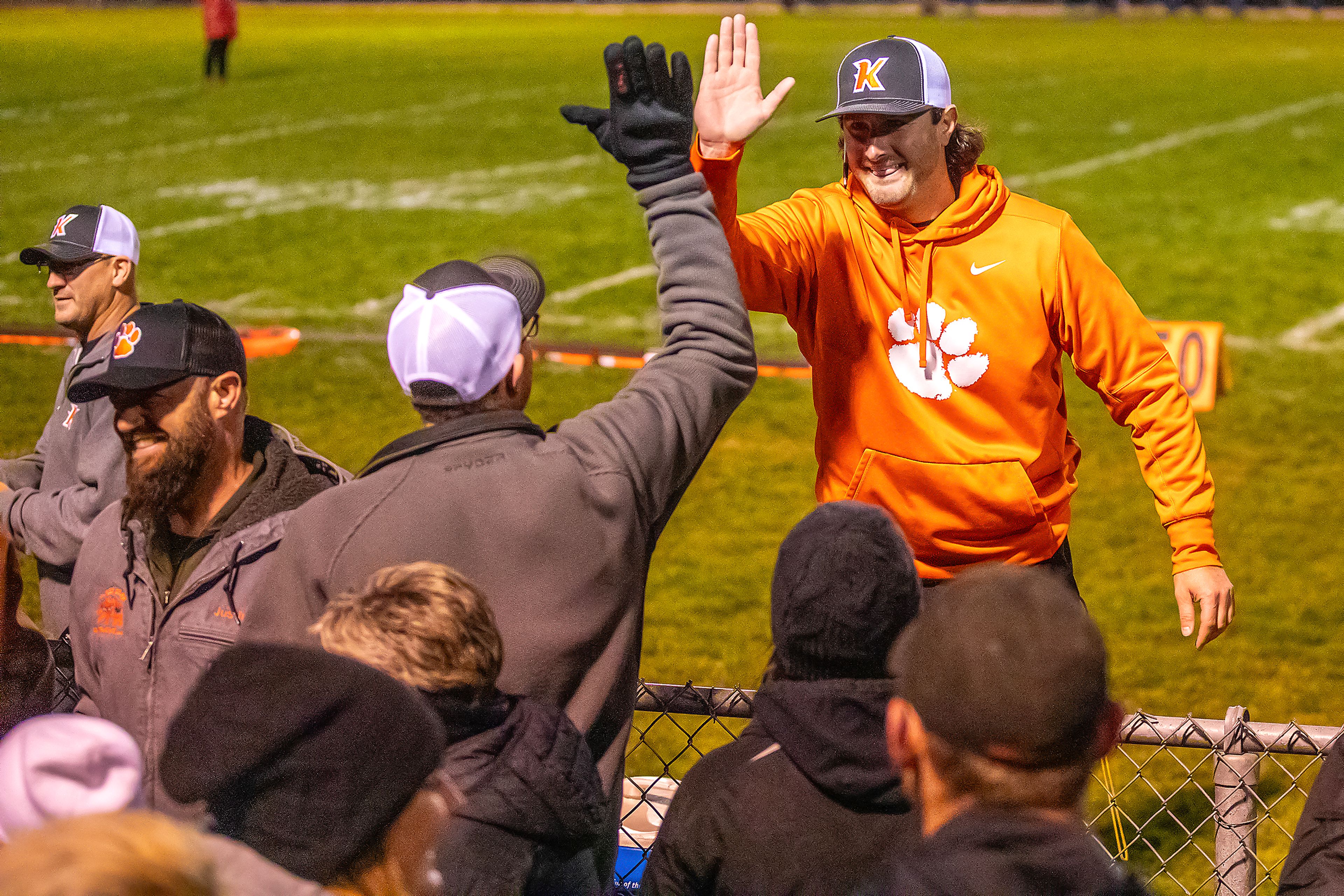 Kendrick head coach Zane Hobart slaps hands with a fan following their victory over Logos in a semifinal game of the Idaho State Football Class 2A Championships Friday at Bengal Field in Lewiston.