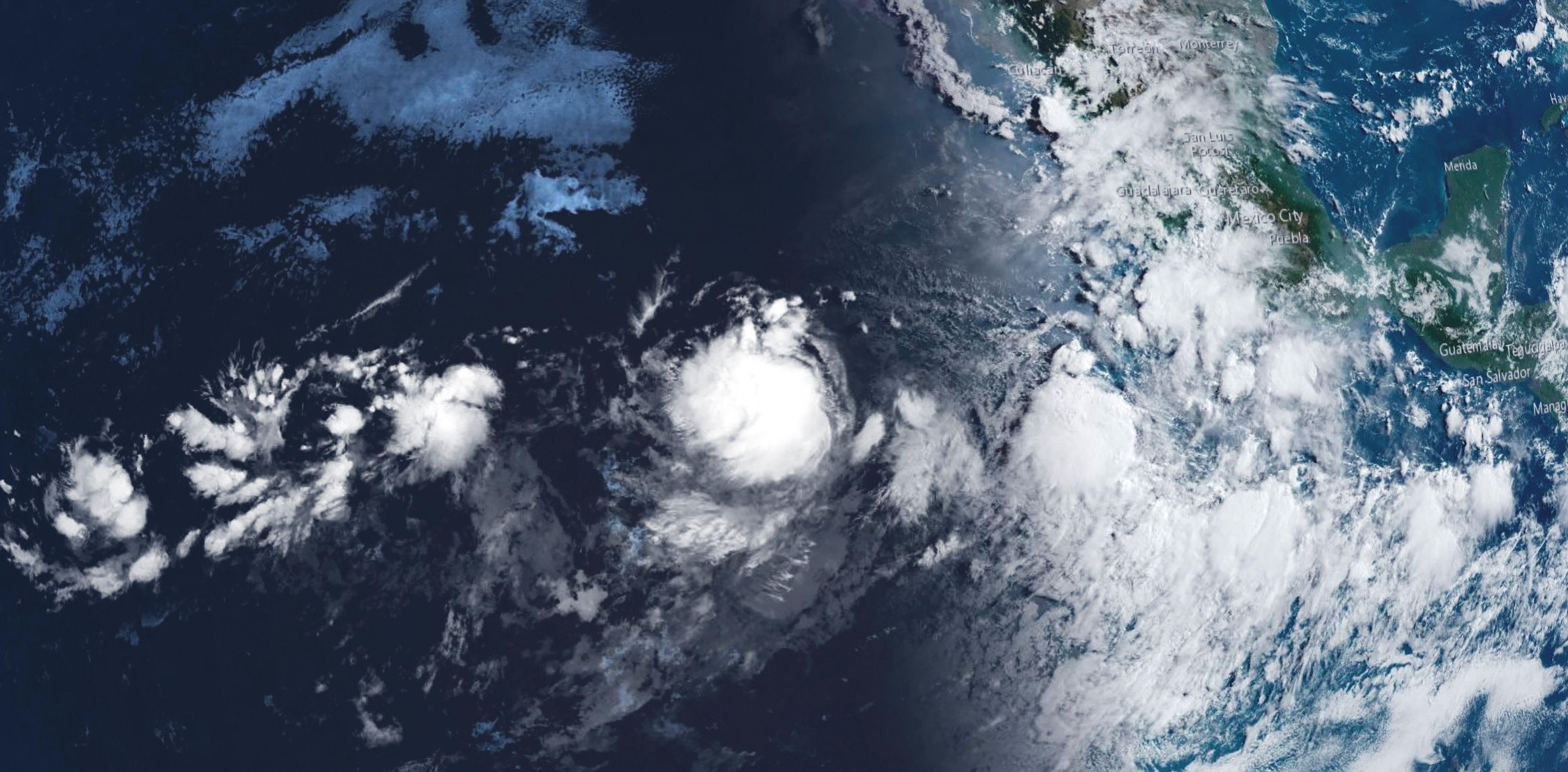 This image provided by the National Oceanic and Atmospheric Administration shows Tropical Storm Gilma, at center, Monday, Aug. 19, 2024. (National Oceanic and Atmospheric Administration via AP)