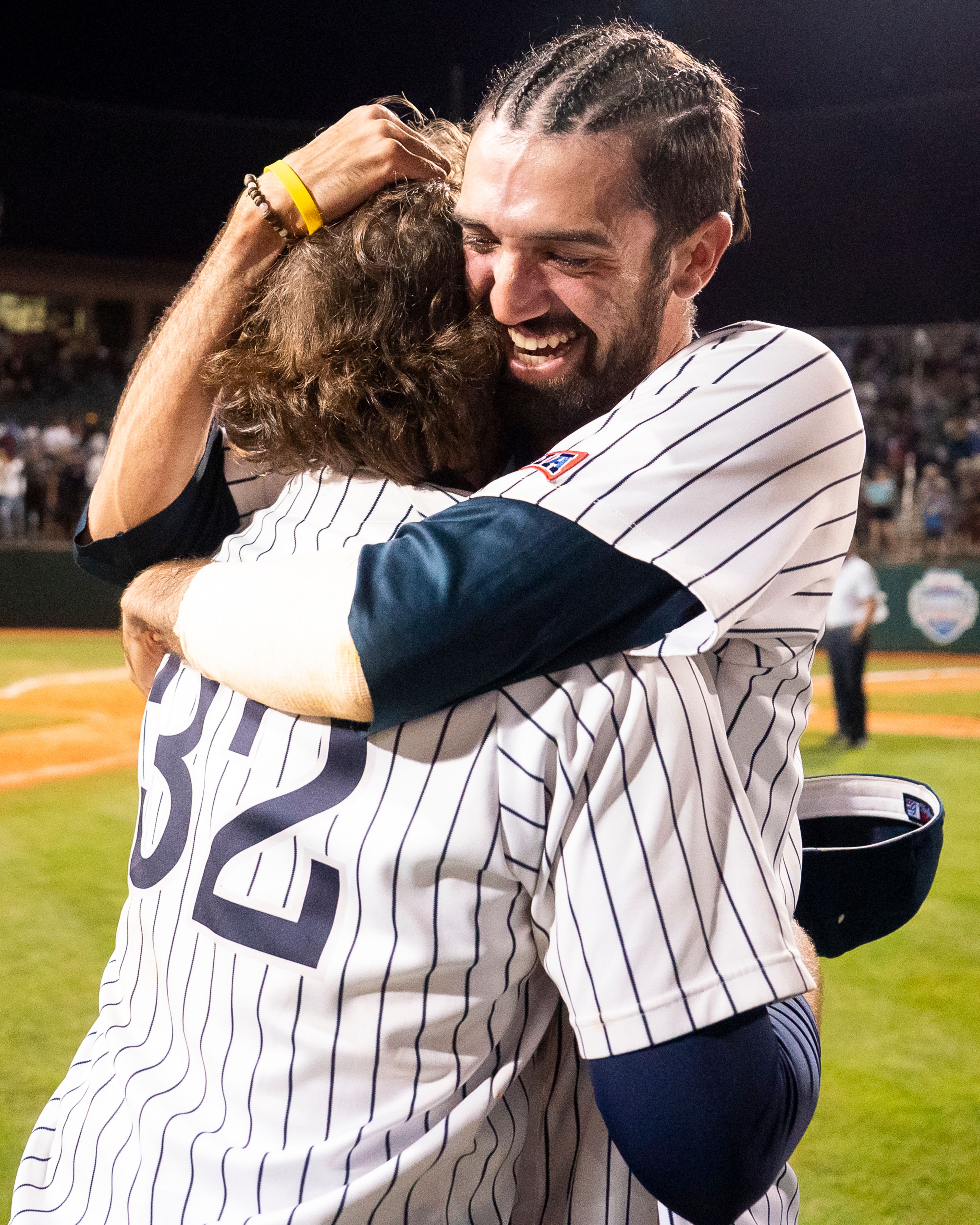 Hope International pitcher Josh Landry, right, hugs closing pitcher Trey Seeley after winning Game 19 of the NAIA World Series against Tennessee Wesleyan on Friday at Harris Field in Lewiston.