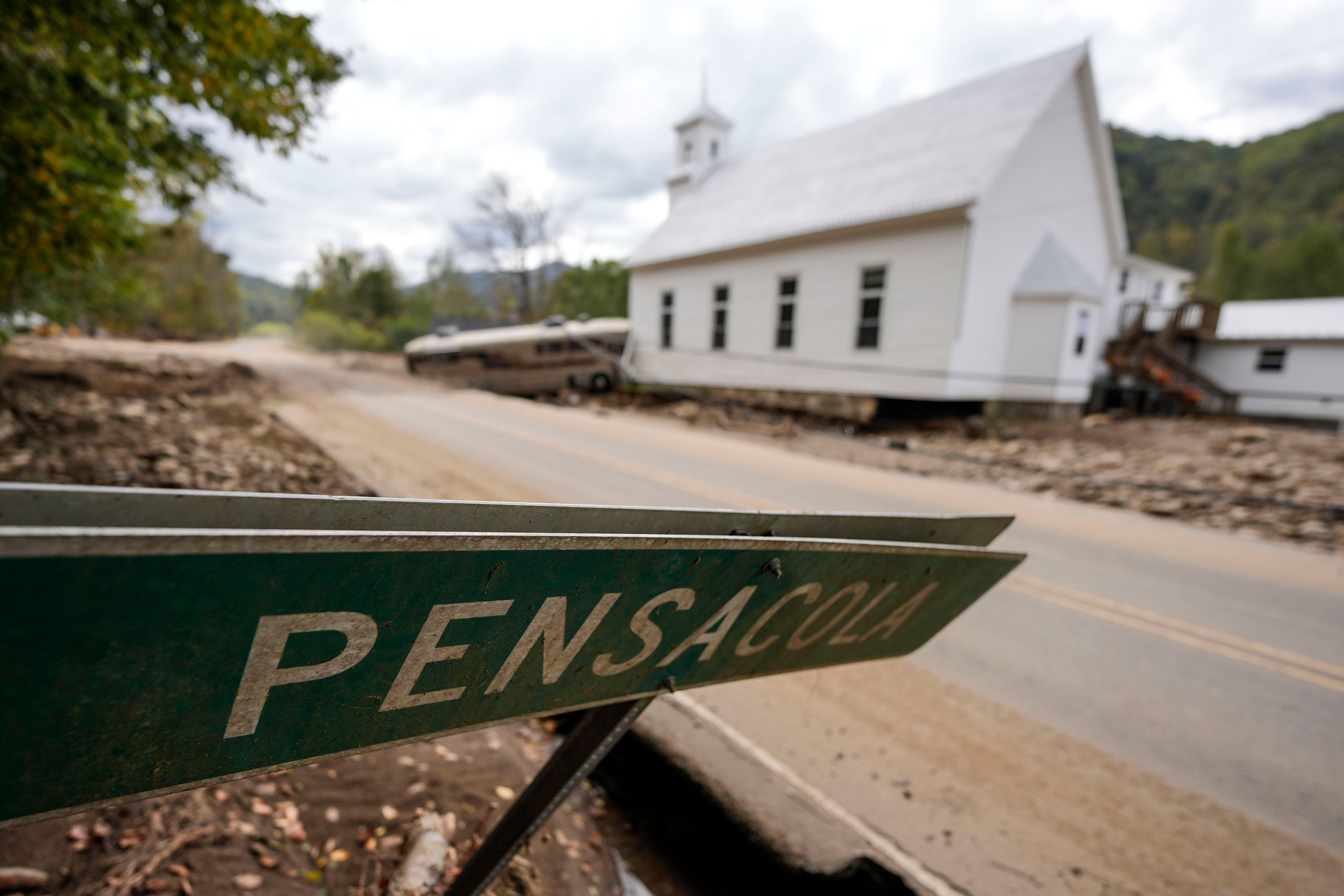 The town sign is seen in the aftermath of Hurricane Helene, Thursday, Oct. 3, 2024, in Pensacola, N.C. (AP Photo/Mike Stewart)