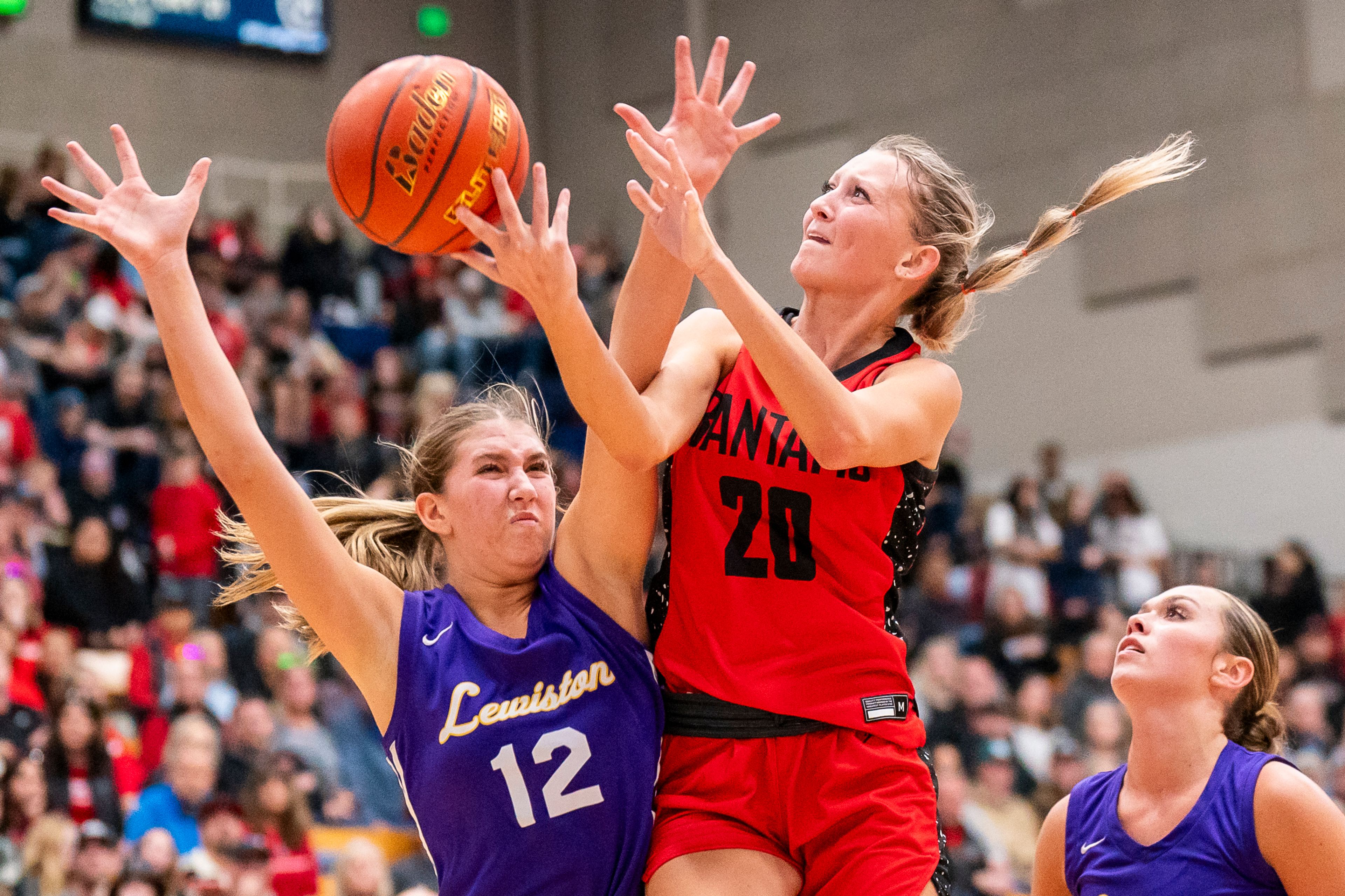 Clarkston’s Eloise Teasley (20) is fouled as she goes up for a shot during their Golden Throne rivalry game against Lewiston on Friday inside the P1FCU Activity Center in Lewiston.