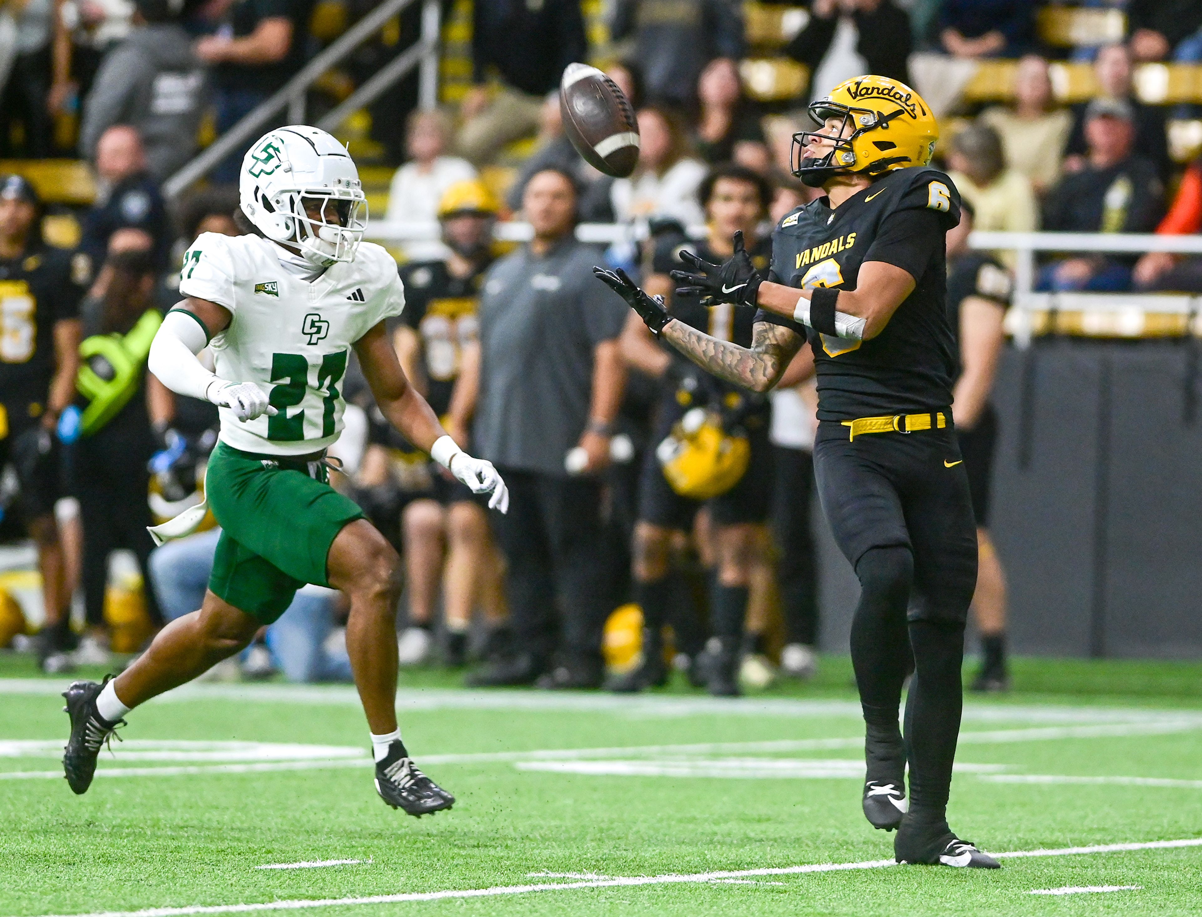 Idaho wide receiver Jordan Dwyer attempts to catch a pass with pressure from Cal Poly cornerback Calvin Moore Saturday at the P1FCU Kibbie Dome in Moscow.,