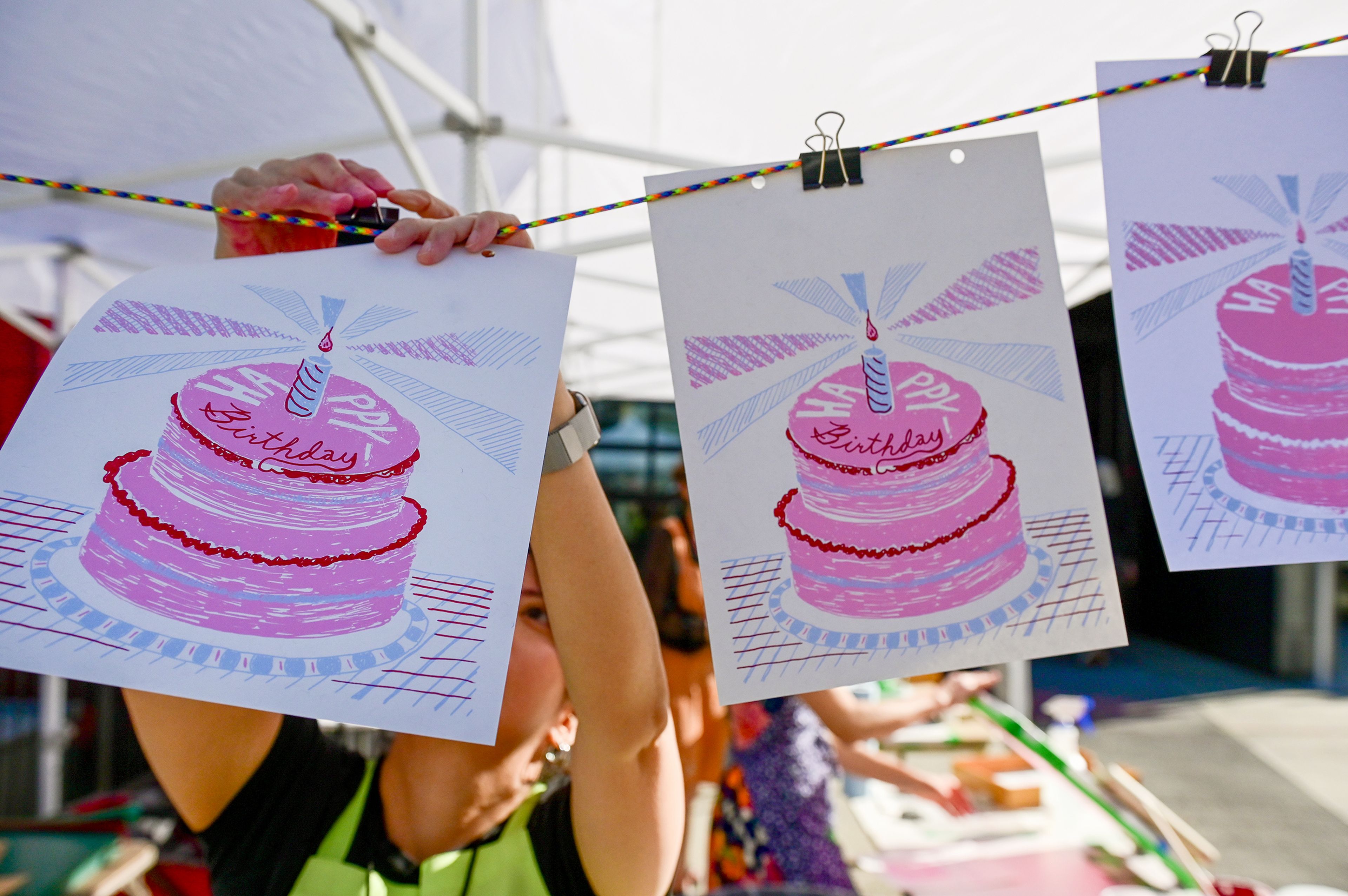 Screenprinted art with a happy birthday wish is hung to dry outside of the Jordan Schnitzer Museum of Art at Washington State University before the museums 50 years reception and book release Thursday in Pullman.,