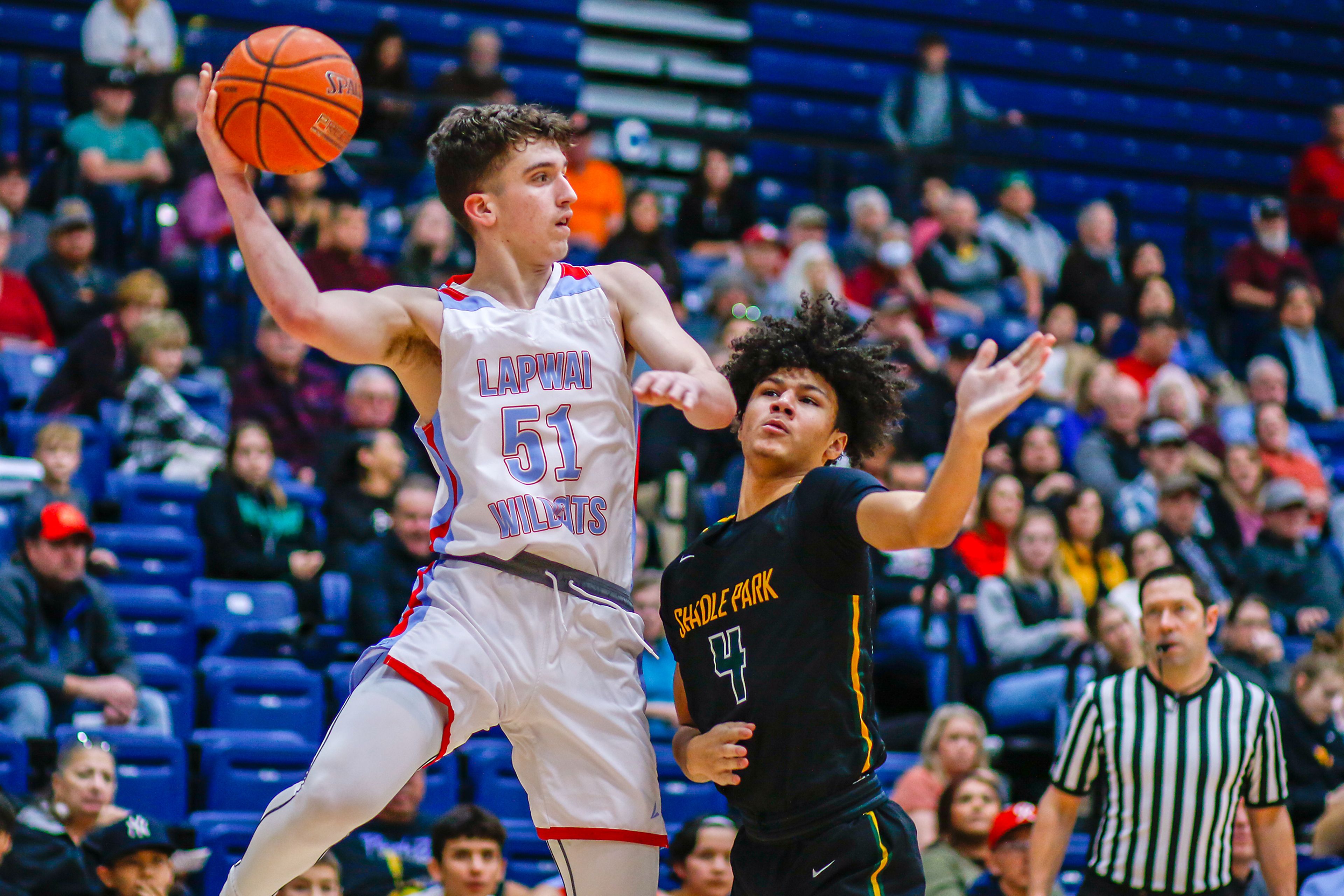 Lapwai guard Kase Wynott jumps to pass the ball as Shadle Park guard Jordan Dever defends during Thursday's Avista Holiday Tournament boys basketball final at the P1FCU Activity Center in Lewiston.