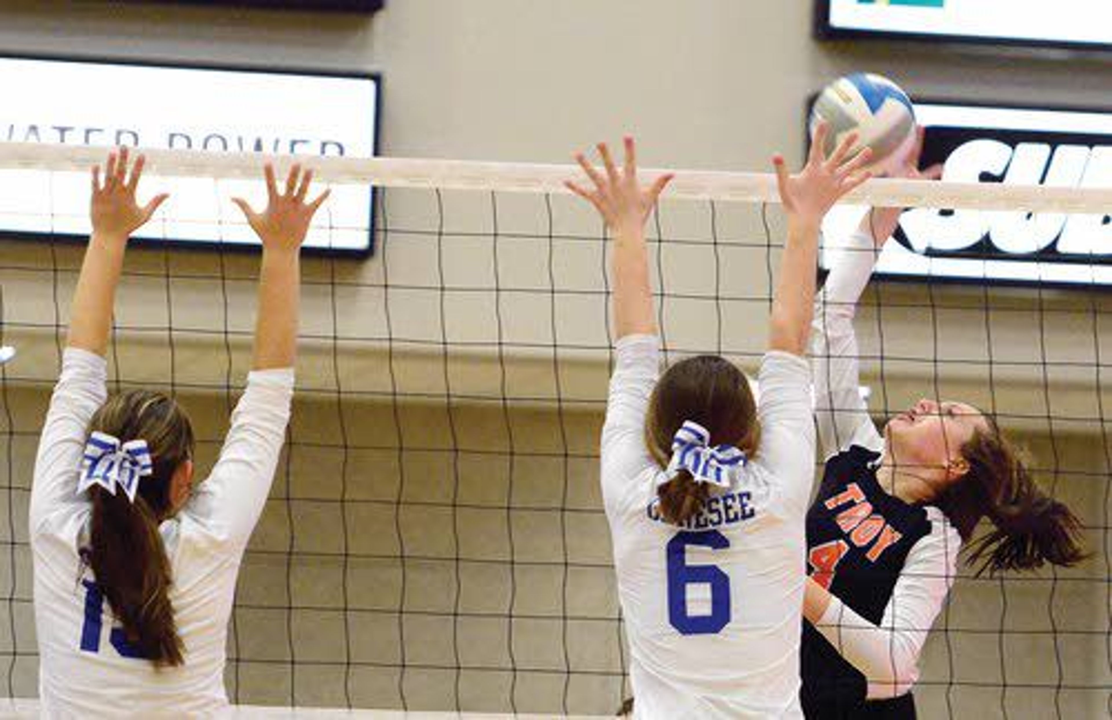 Troy outside hitter Lindsey Kwate looks to spike the ball past the Genesee front line during the fourth set of the Class 1A Division I District II championship match on Tuesday night.