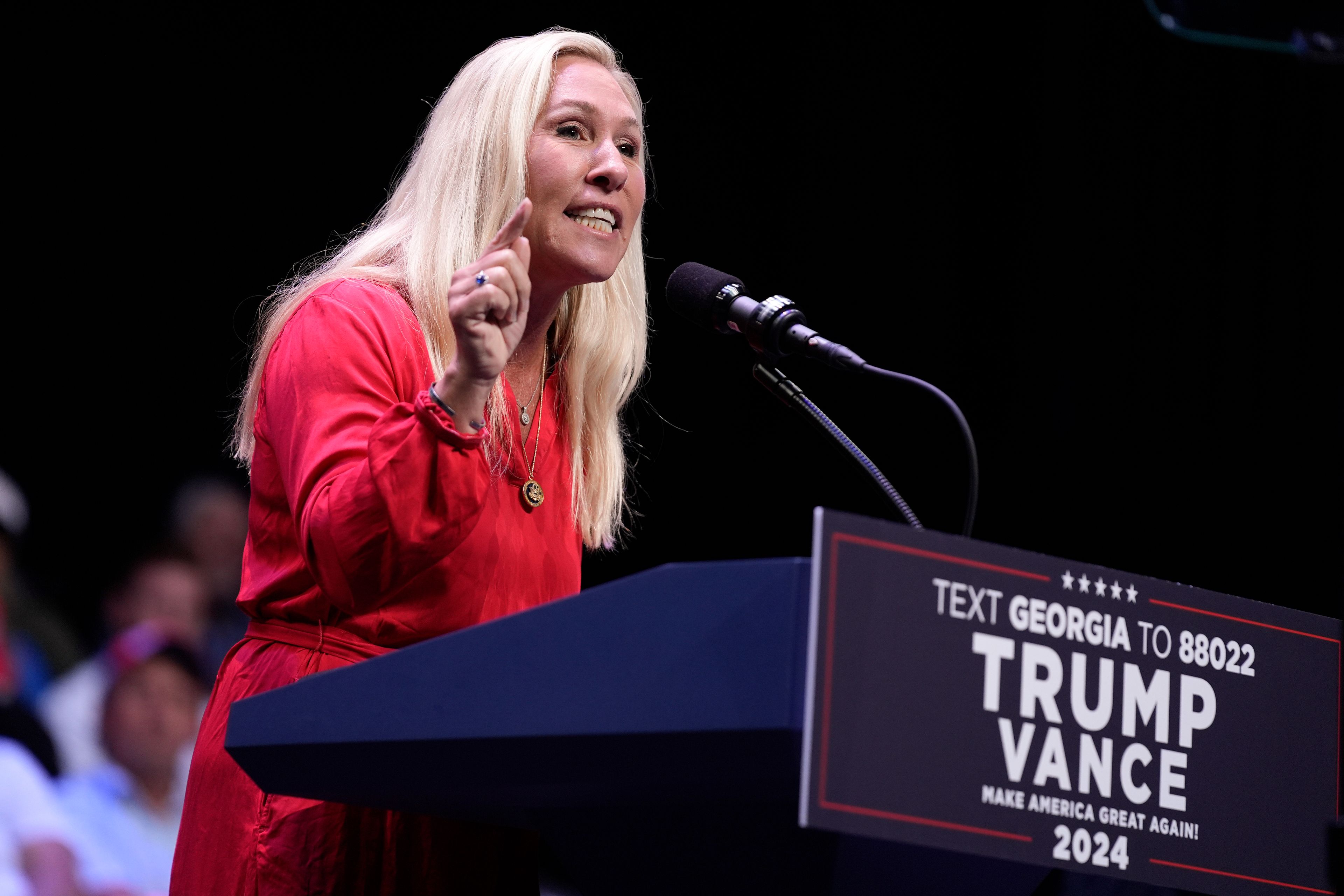 Rep. Marjorie Taylor Greene, R-Ga., speaks before Republican presidential candidate former President Donald Trump arrives to deliver remarks on the tax code, and manufacturing at the Johnny Mercer Theatre Civic Center, Tuesday, Sept. 24, 2024, in Savannah, Ga. (AP Photo/Evan Vucci)