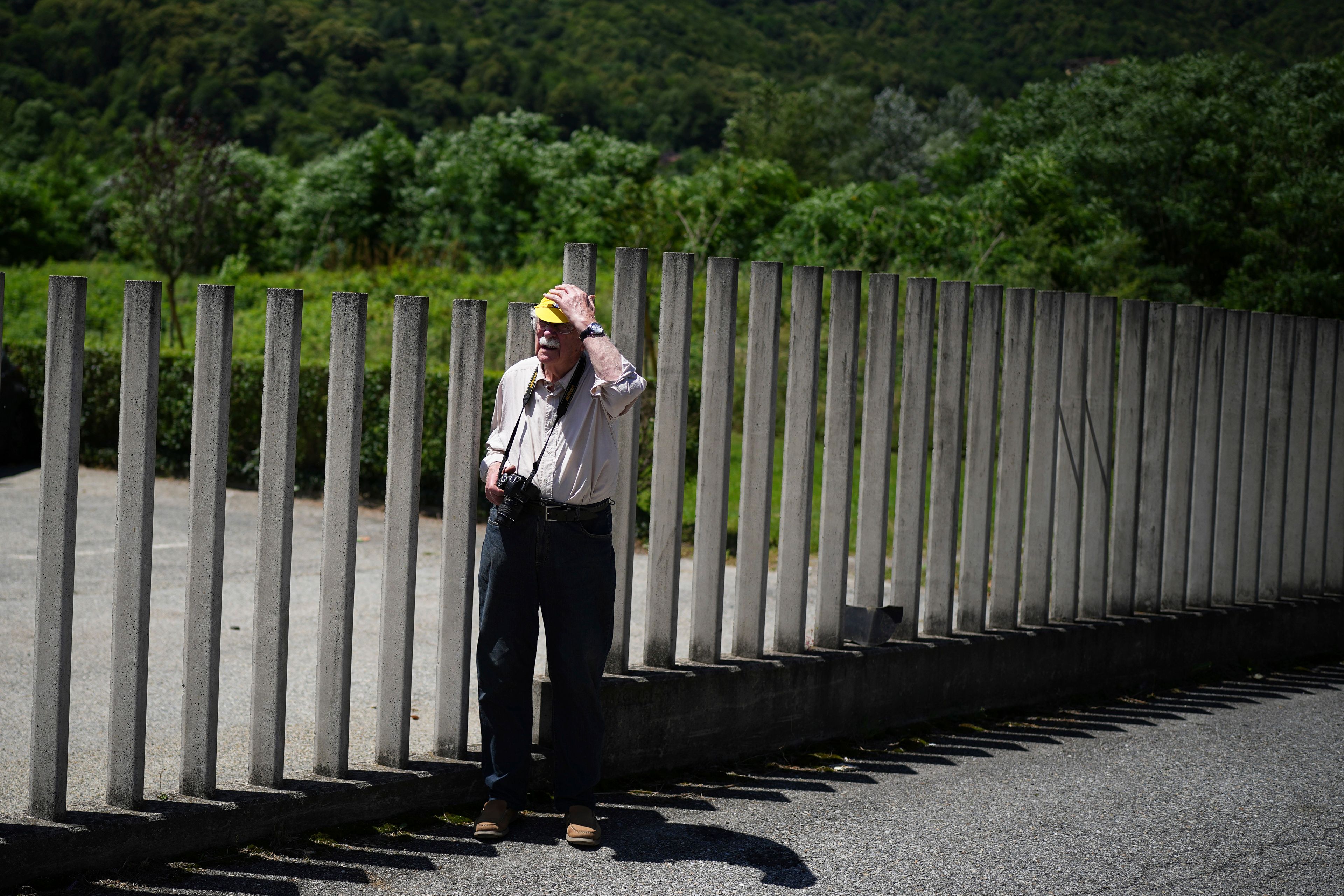 A lone spectator waits for the riders to pass during the fourth stage of the Tour de France cycling race over 139.6 kilometers (86.7 miles) with start in Pinerolo, Italy and finish in Valloire, France, Tuesday, July 2, 2024. (AP Photo/Daniel Cole)