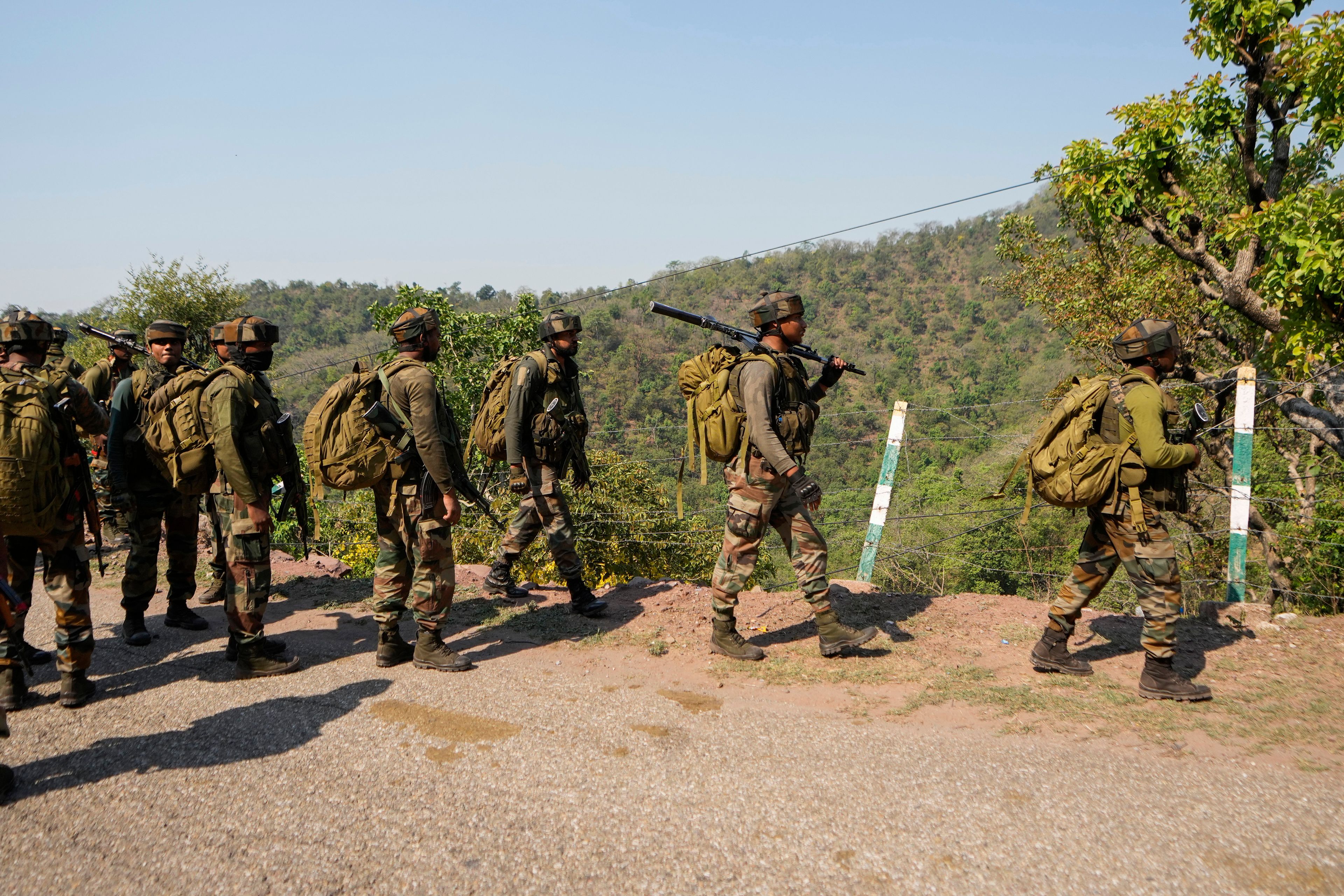 Indian army soldiers patrol the area where a bus fell into a deep gorge on Sunday after being fired at by suspected militants in Reasi district, Jammu and Kashmir, Monday, June 10, 2024. The bus was carrying pilgrims to the base camp of the famed Hindu temple Mata Vaishno Devi when it came under attack killing at least nine people.