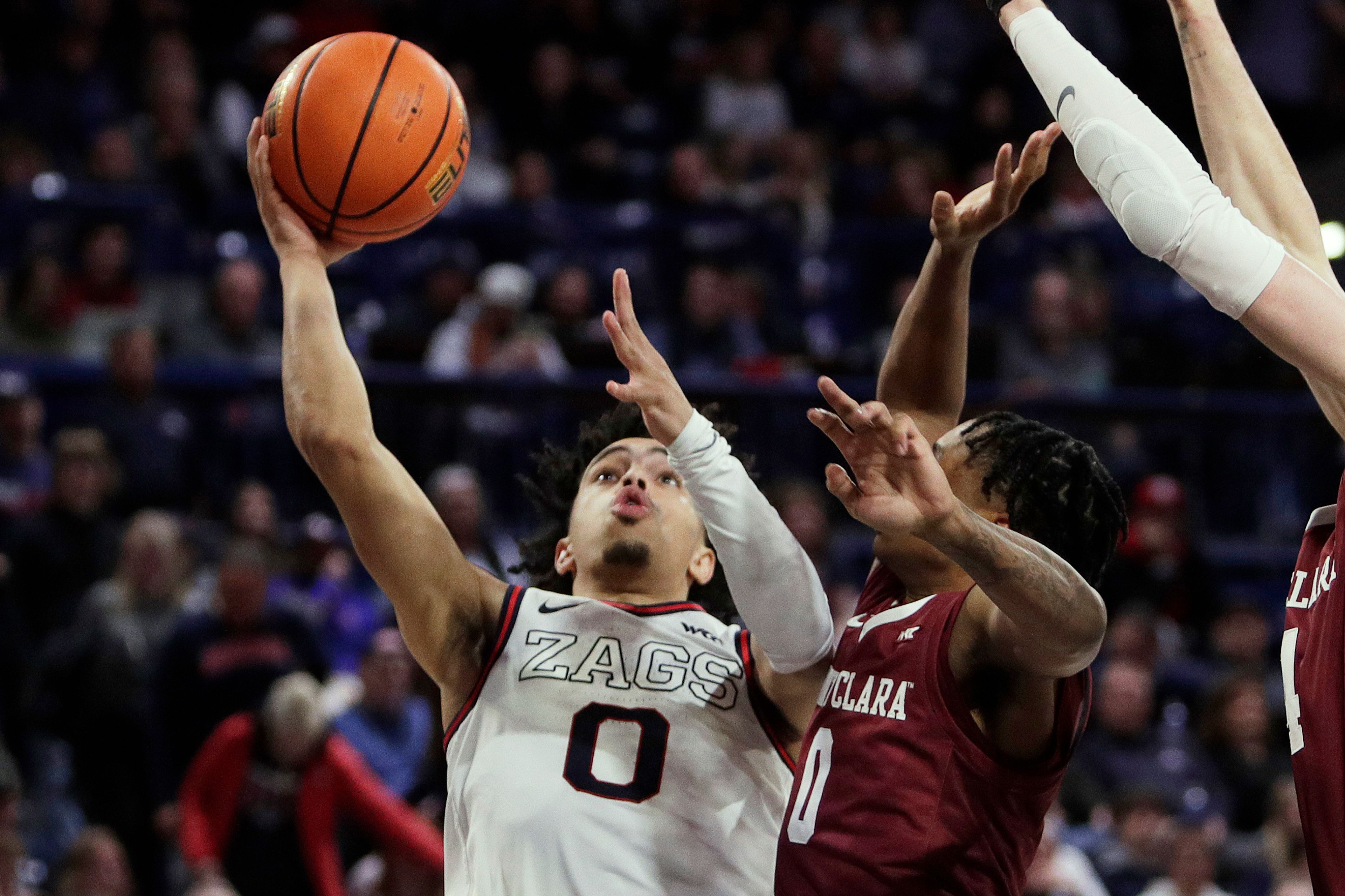 Gonzaga guard Ryan Nembhard, left, shoots while pressured by Santa Clara guard Brenton Knapper, center, during a game Saturday in Spokane.