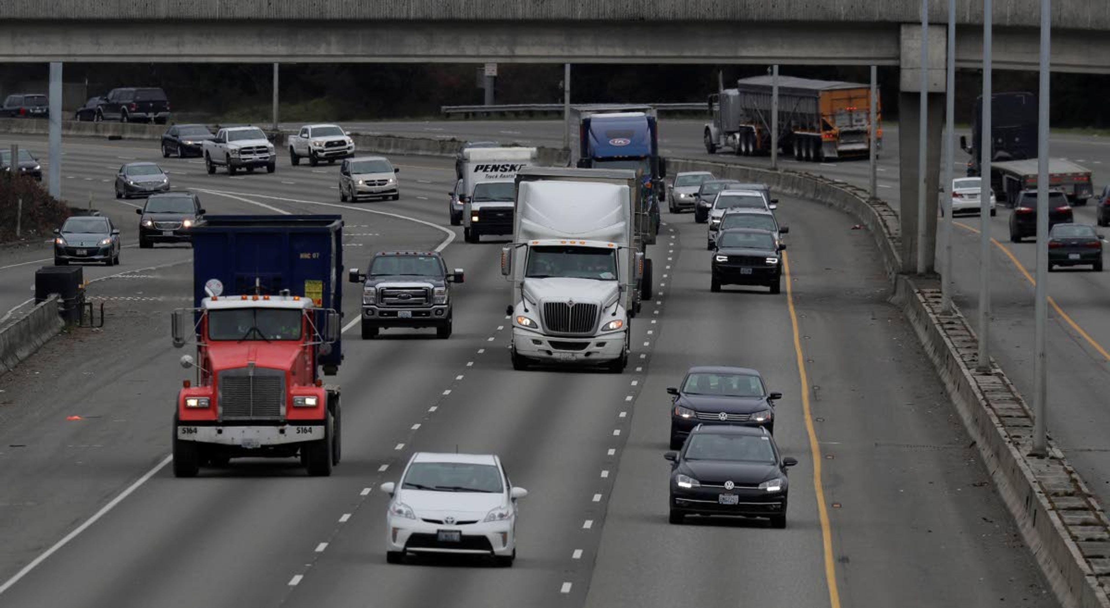 Cars and trucks travel on Interstate Highway 5 near Olympia, Wash., Monday, March 25, 2019. Democrats in the Washington House released their two-year transportation budget proposal Monday, which includes $9.9 billion in spending for projects. (AP Photo/Ted S. Warren)