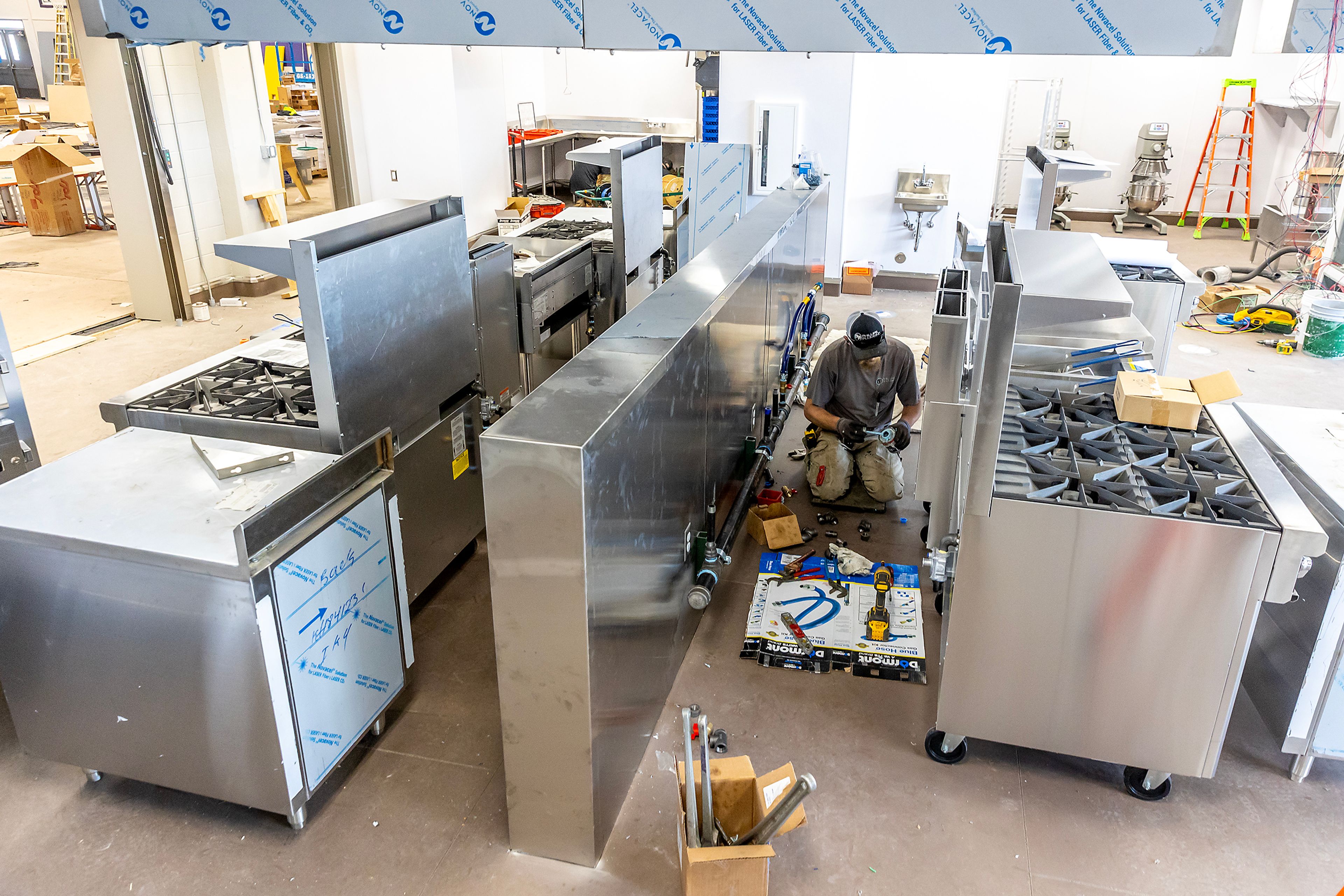 Work continues on the new commercial kitchen being installed at Booth Hall Wednesday in Lewiston.