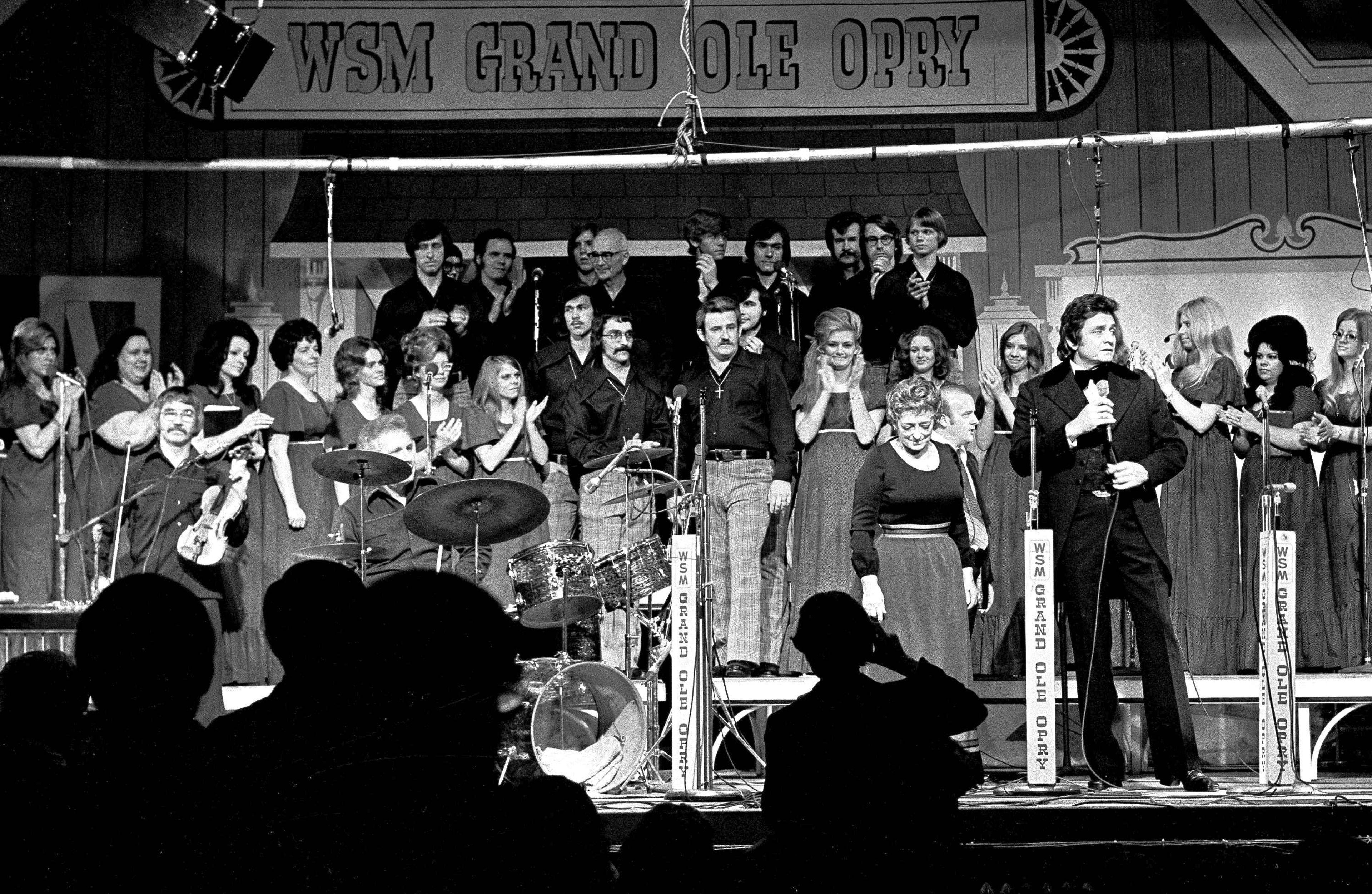 FILE - Country music stars, including Johnny Cash, foreground right, and Maybelle Carter, next to Cash, perform during the Grand Ole Opry's last show at Ryman Auditorium in Nashville, Tenn., March 18, 1974.