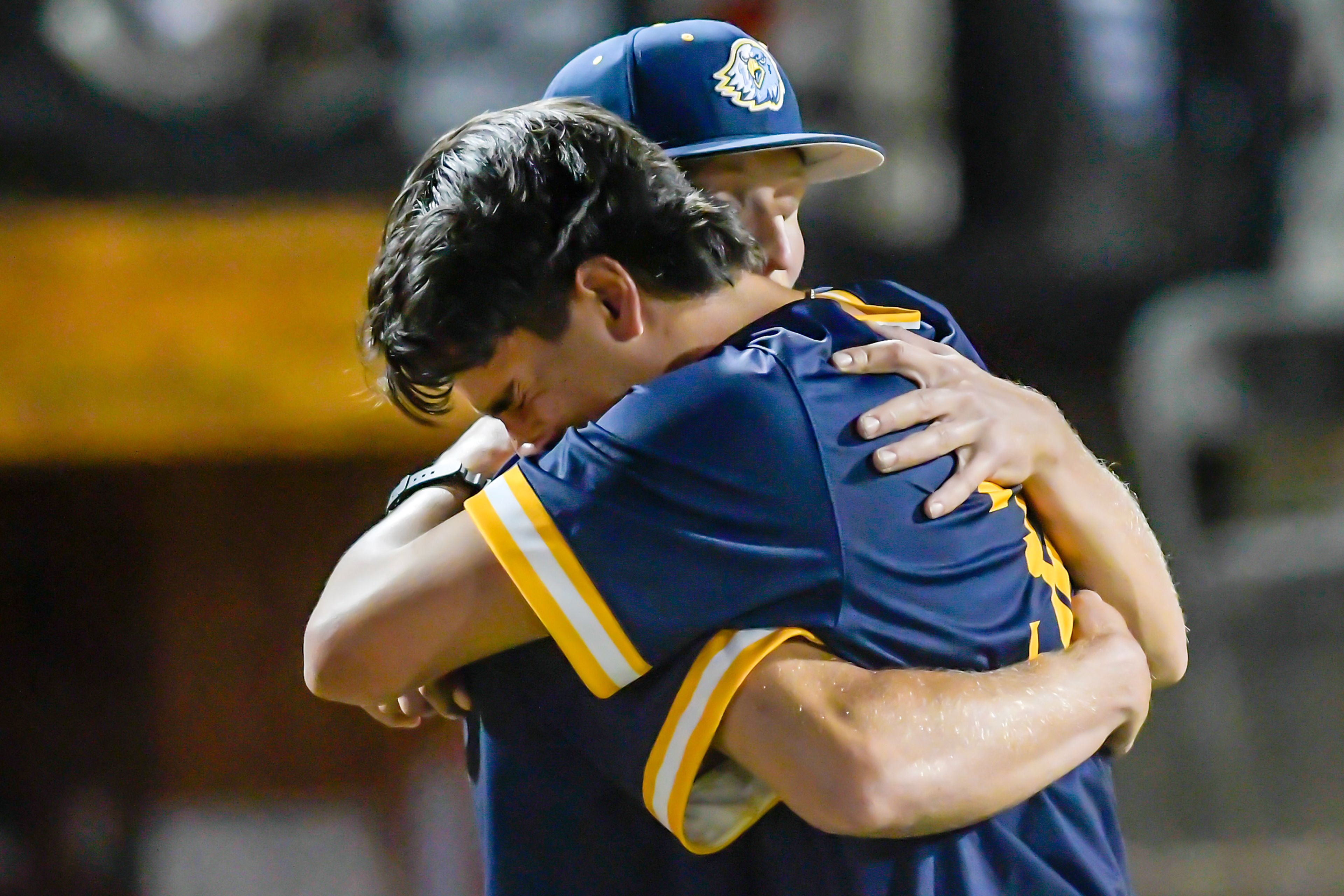 Reinhardt players embrace after falling to Tennessee Wesleyan in Game 18 of the NAIA World Series at Harris Field Thursday in Lewiston.