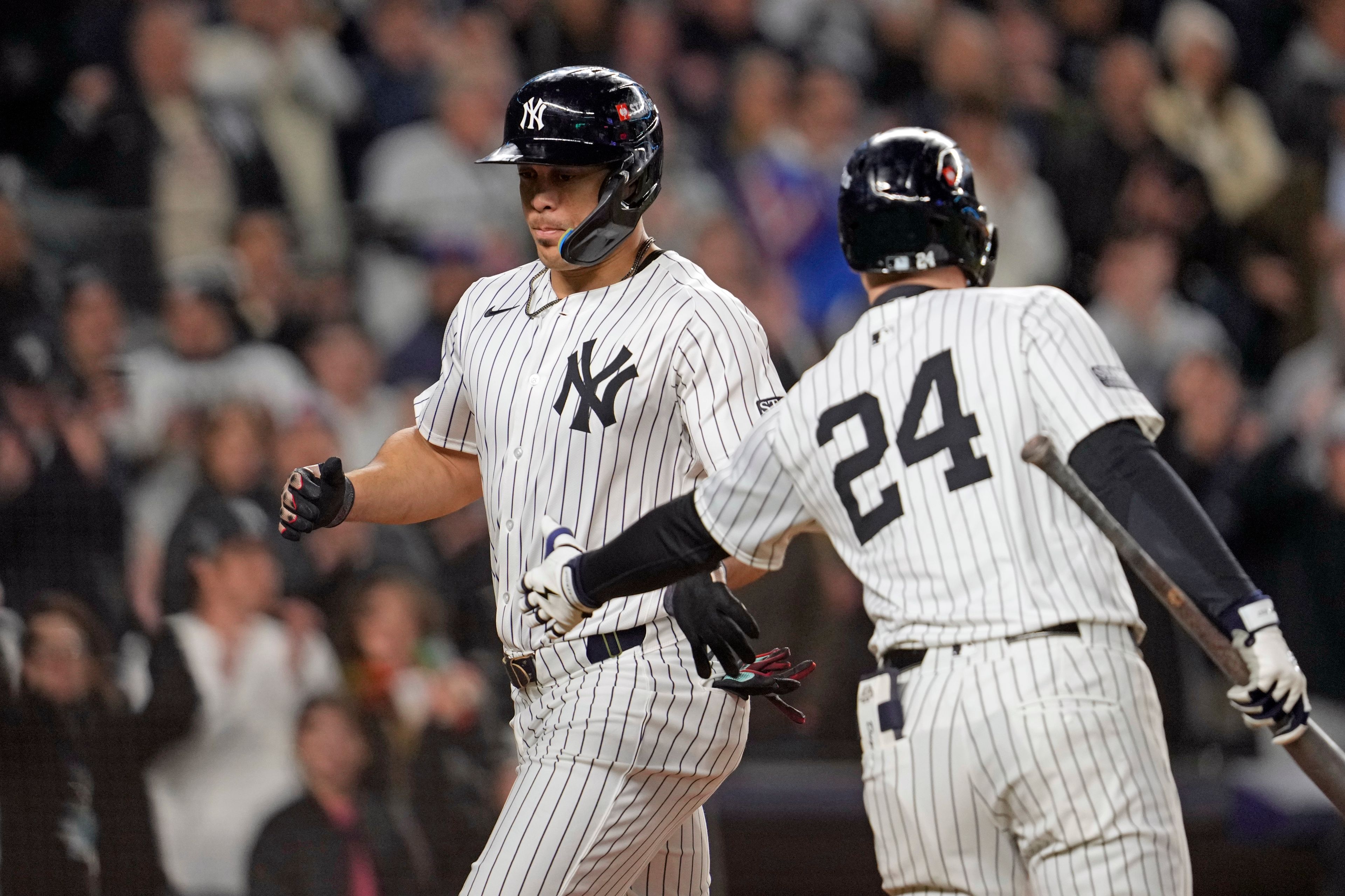 New York Yankees' Juan Soto, left, celebrates with Alex Verdugo (24) after scoring on a wild pitch against the Cleveland Guardians during the third inning in Game 1 of the baseball AL Championship Series Monday, Oct. 14, 2024, in New York. (AP Photo/Godofredo VÃ¡squez)