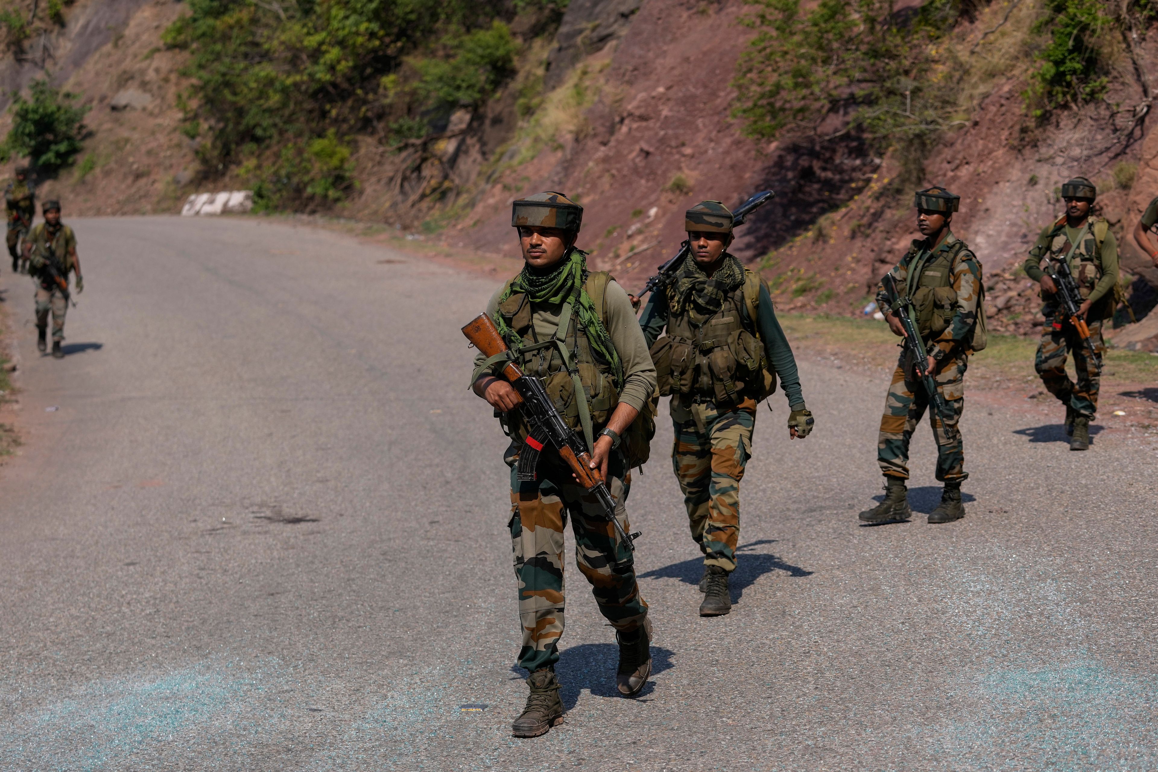 Indian army soldiers patrol the area where a bus fell into a deep gorge on Sunday after being fired at by suspected militants in Reasi district, Jammu and Kashmir, Monday, June 10, 2024. The bus was carrying pilgrims to the base camp of the famed Hindu temple Mata Vaishno Devi when it came under attack killing at least nine people.