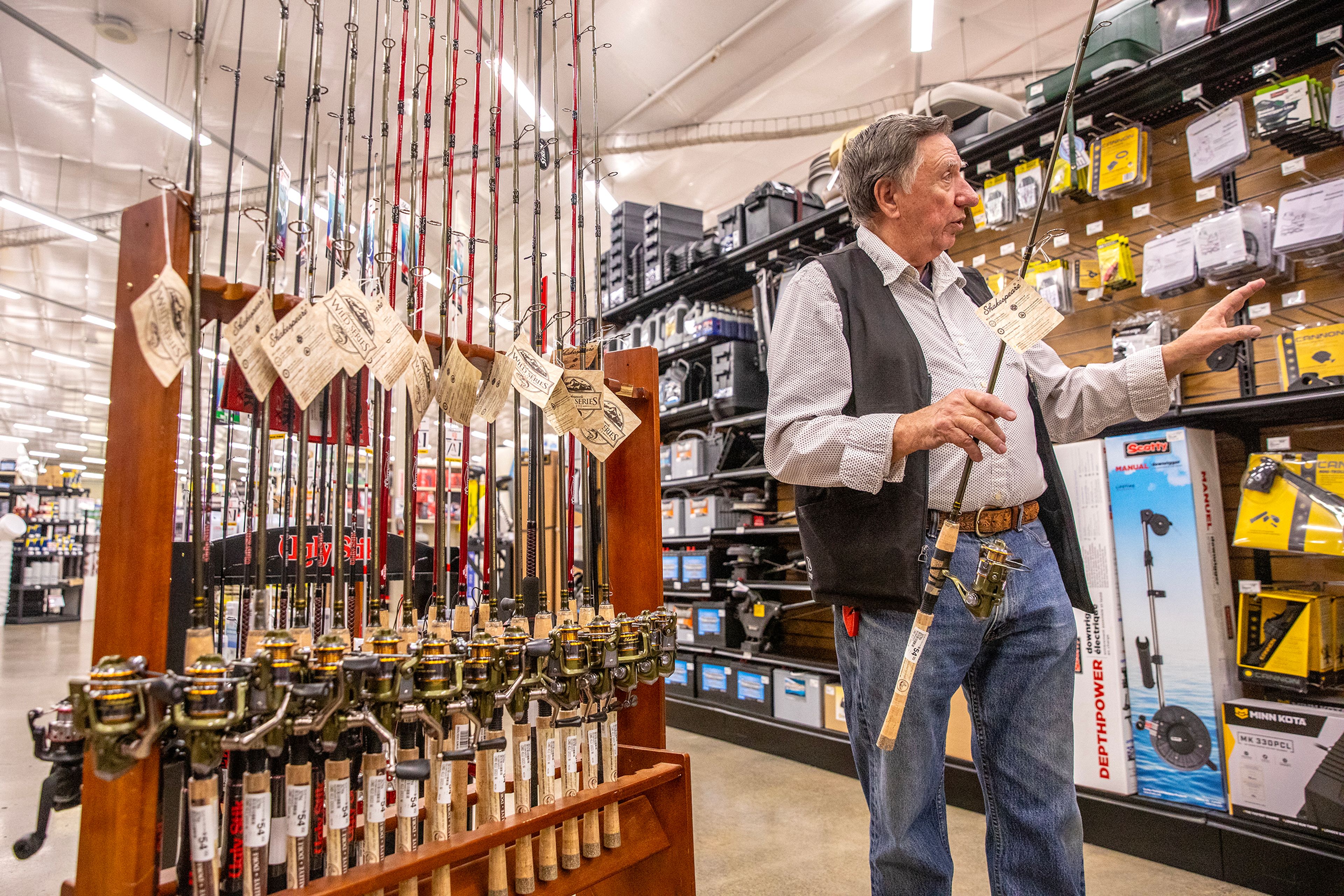 John Snaza talks about his recommendations for walleye fishing as he holds his recommended rod, a Shakespeare Wild Series Walleye, Wednesday at North 40 Outfitters in Lewiston.