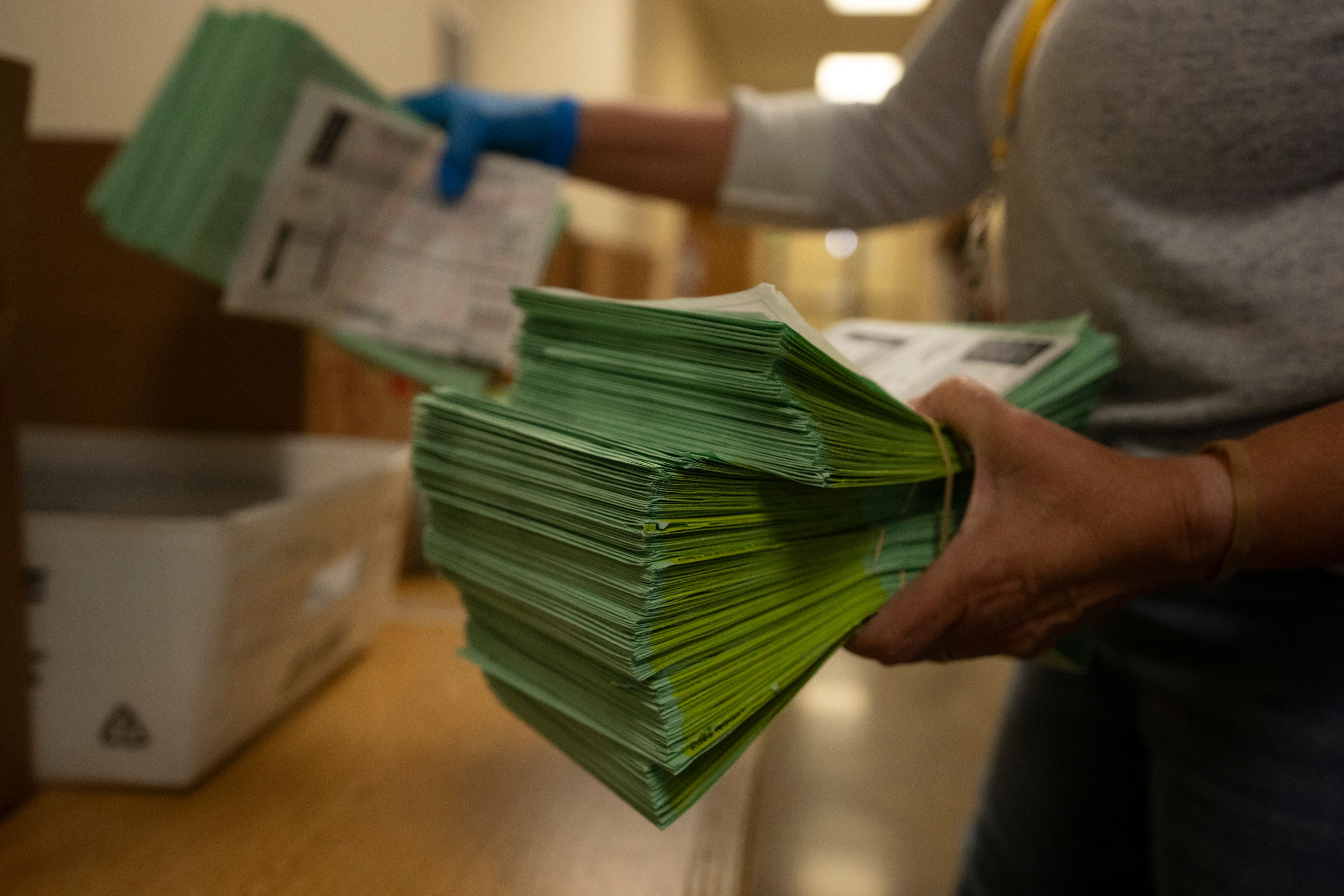 FILE - An election official sorts mail ballots at the Maricopa County Tabulation and Election Center in Phoenix, March 5, 2024. (AP Photo/Serkan Gurbuz, File)