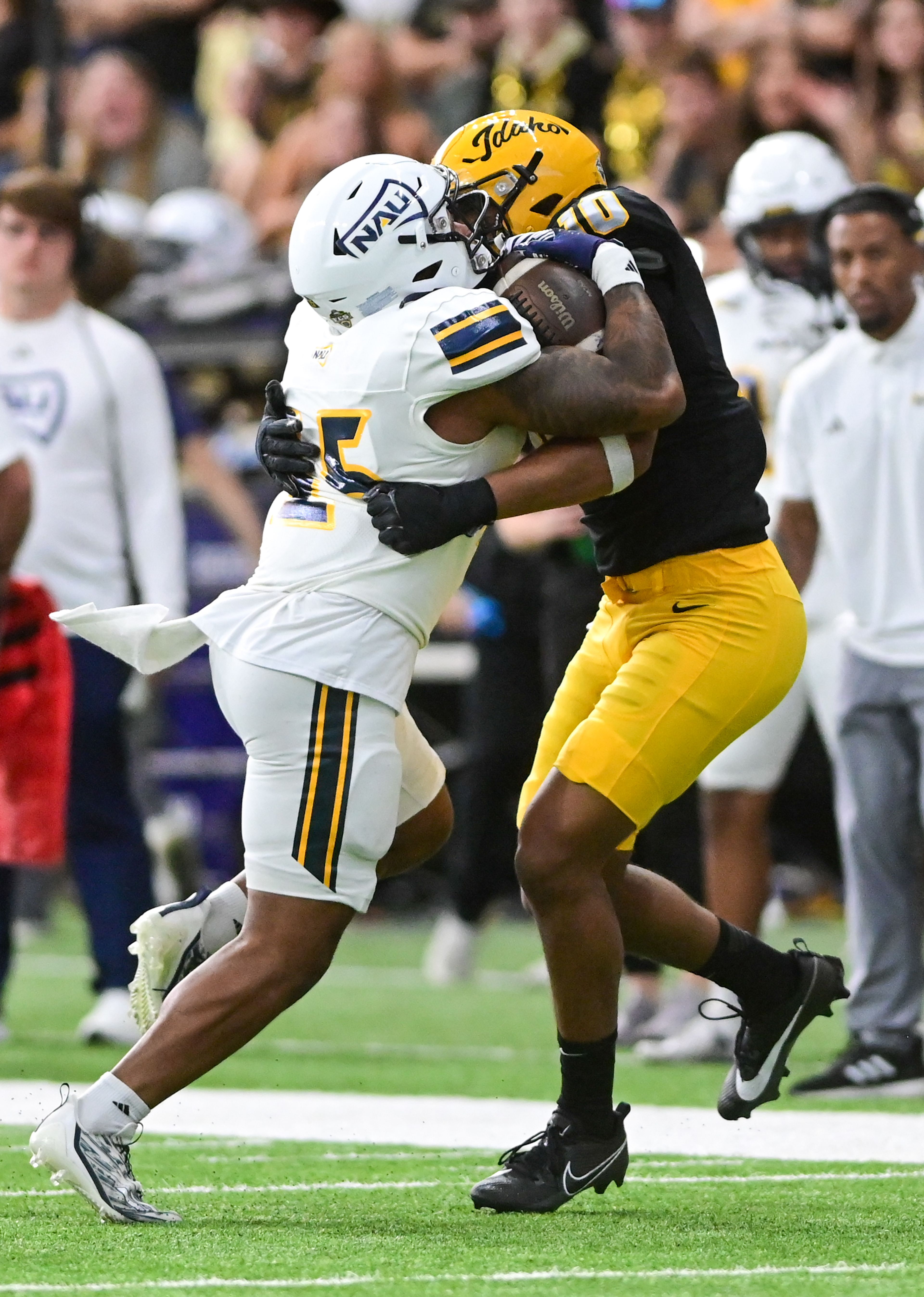 Northern Arizona running back J'Wan Evans is tackled by Idaho linebacker Syrr Barnes Saturday at the P1FCU Kibbie Dome in Moscow.,