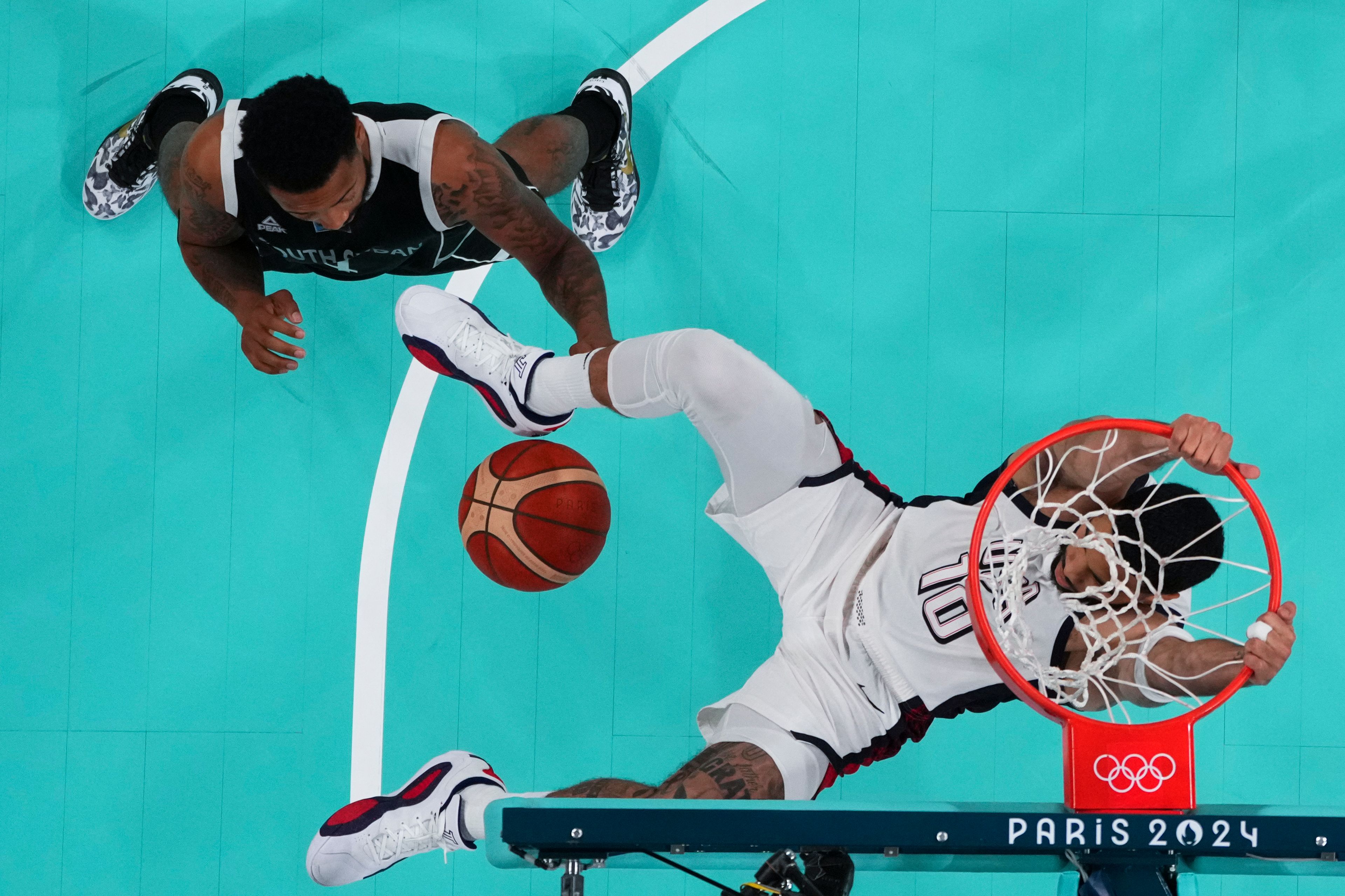 Jayson Tatum, of the United States, gets a dunk over Carlik Jones, of South Sudan, at the 2024 Summer Olympics, Wednesday, July 31, 2024, in Villeneuve-d'Ascq, France. (Brian Snyder/Pool Photo via AP)