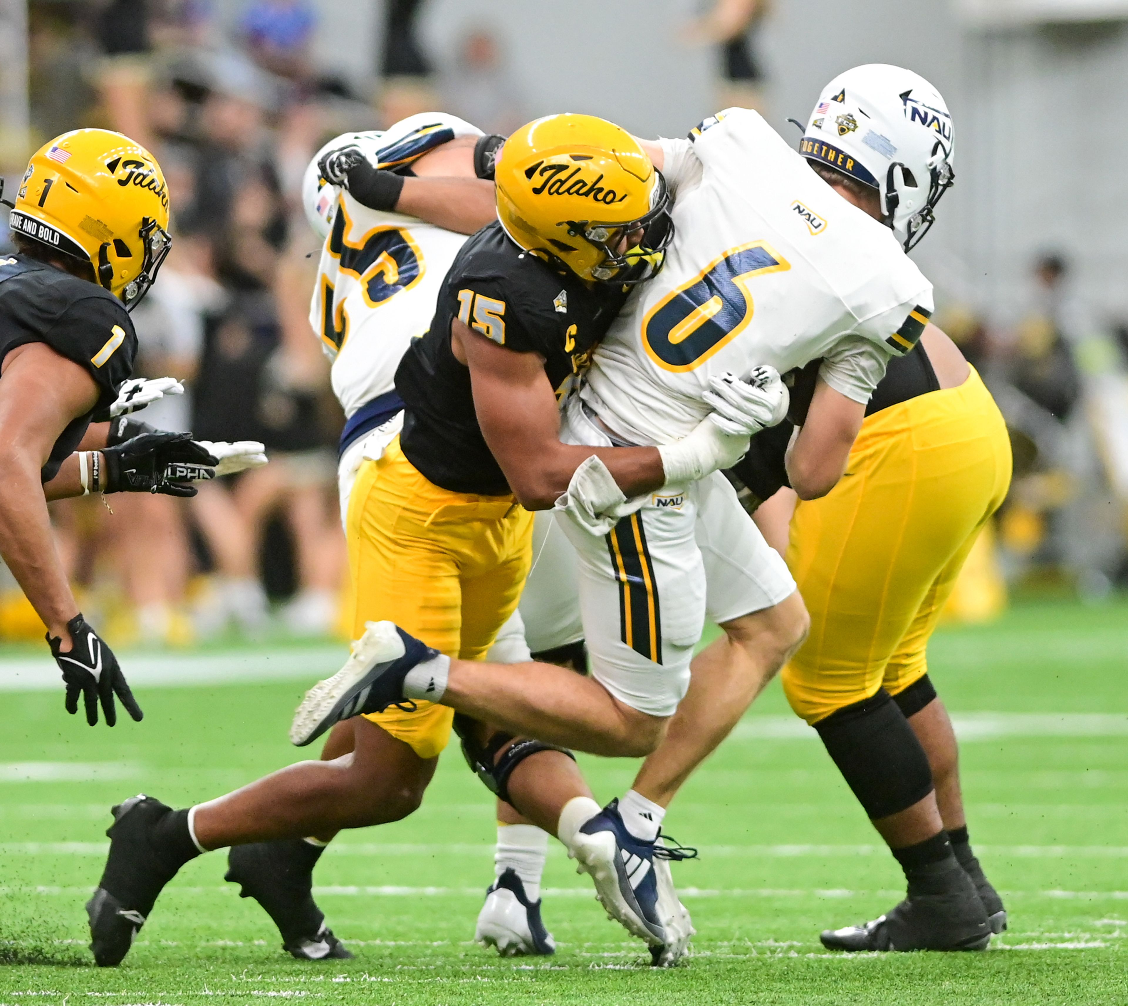 Idaho defensive lineman Malakai Williams tackles Northern Arizona quarterback Ty Pennington during a game Oct. 5 at the P1FCU Kibbie Dome in Moscow.