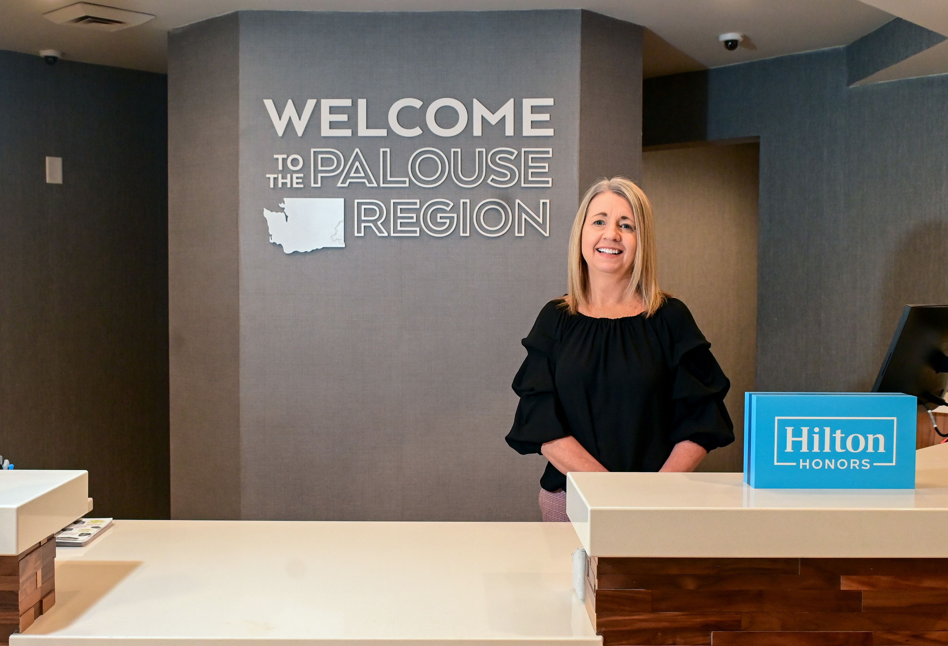 General manager Meghan Wiley stands behind the front desk of the Hampton Inn along Bishop Boulevard in Pullman on Thursday.