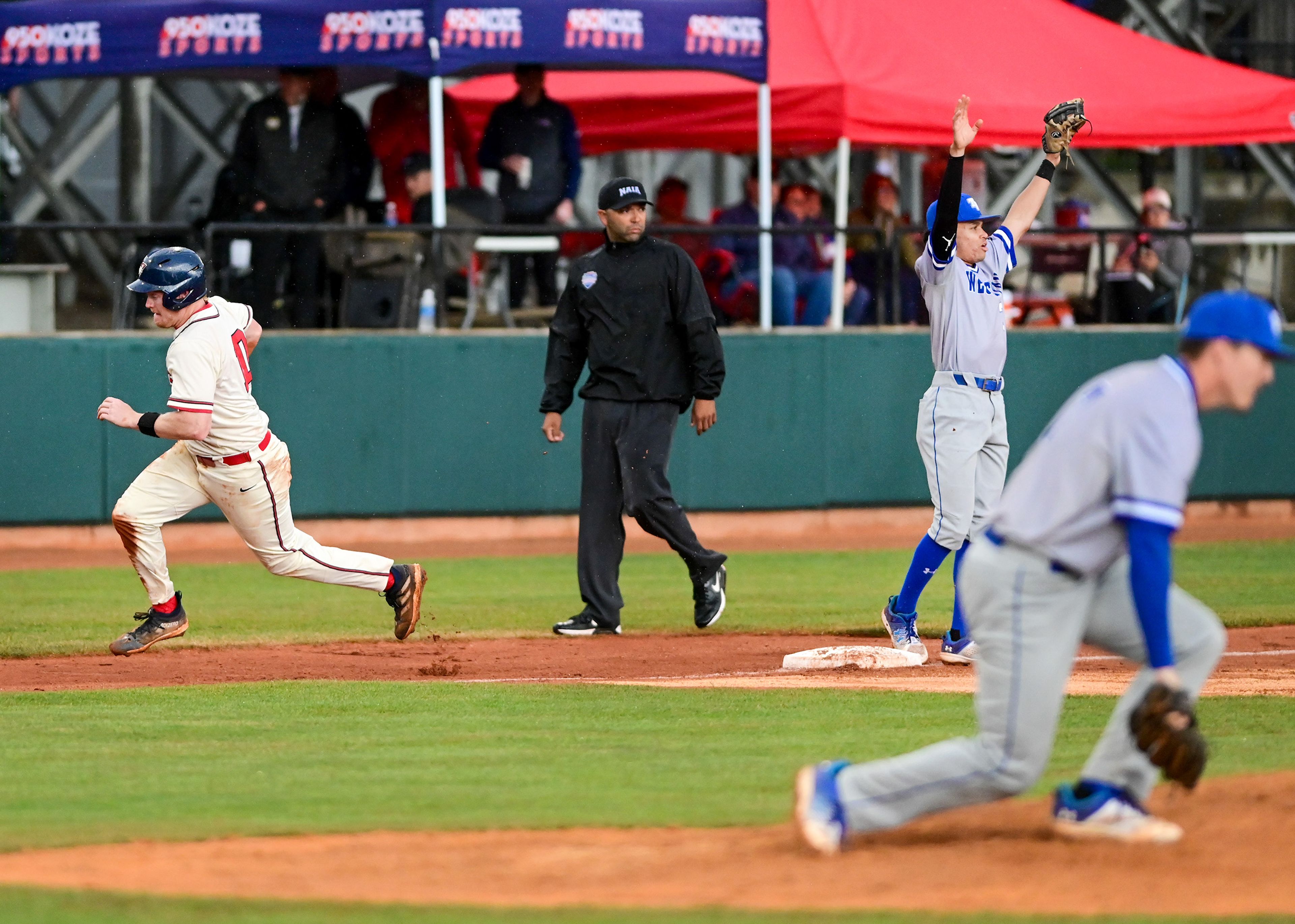 Cumberlands’ Caden Petrey runs through second base as Tennessee Wesleyan’s second baseman Dante Leach calls for the ball on the opening day of the NAIA World Series at Harris Field in Lewiston on Friday.