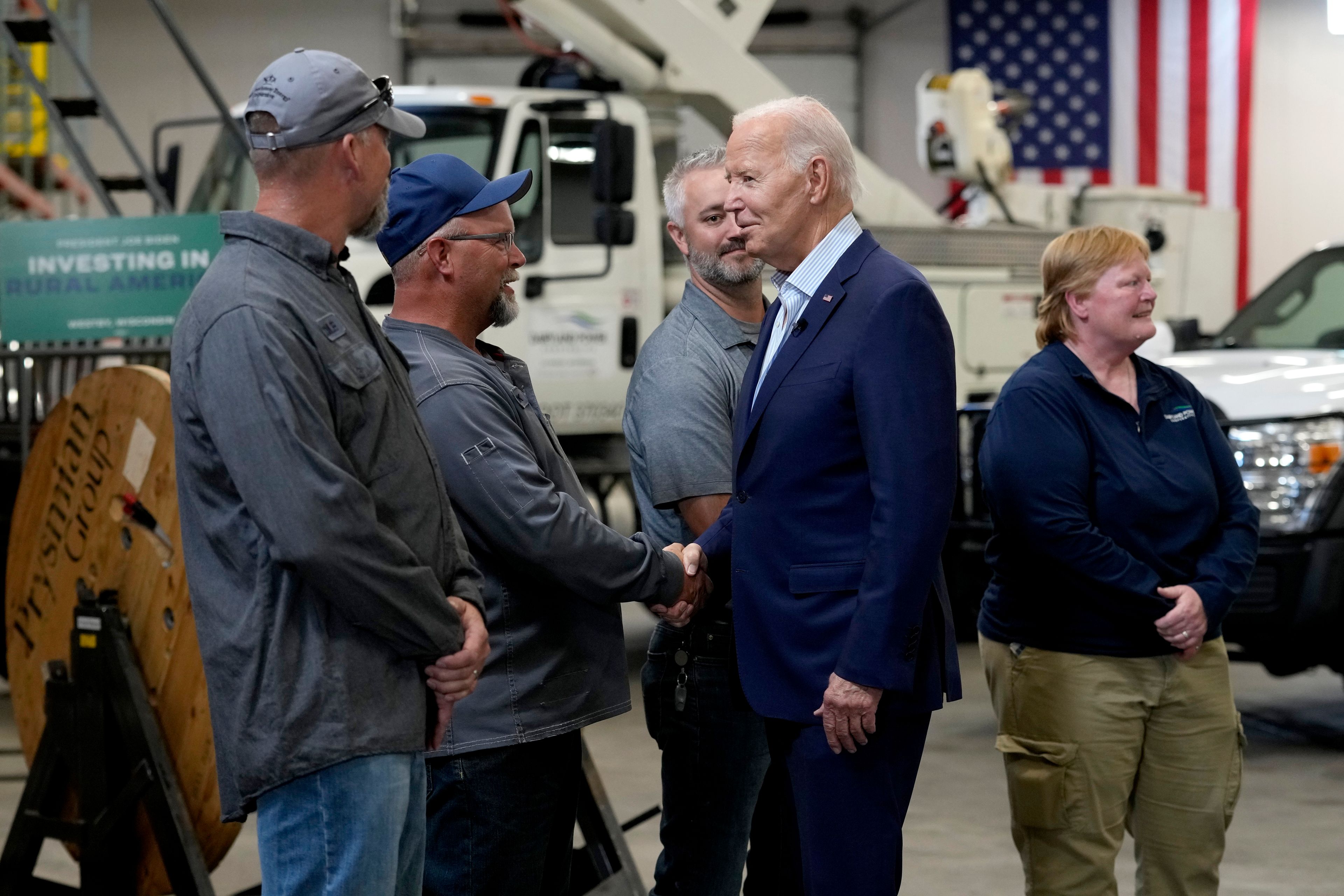 President Joe Biden, second from right, greets workers from Dairyland Power Cooperative and Vernon Electric Cooperative during a visit to Vernon Electric in Westby, Wis., Thursday, Sept. 5, 2024. Biden is in Wisconsin to promote his Investing in America agenda.