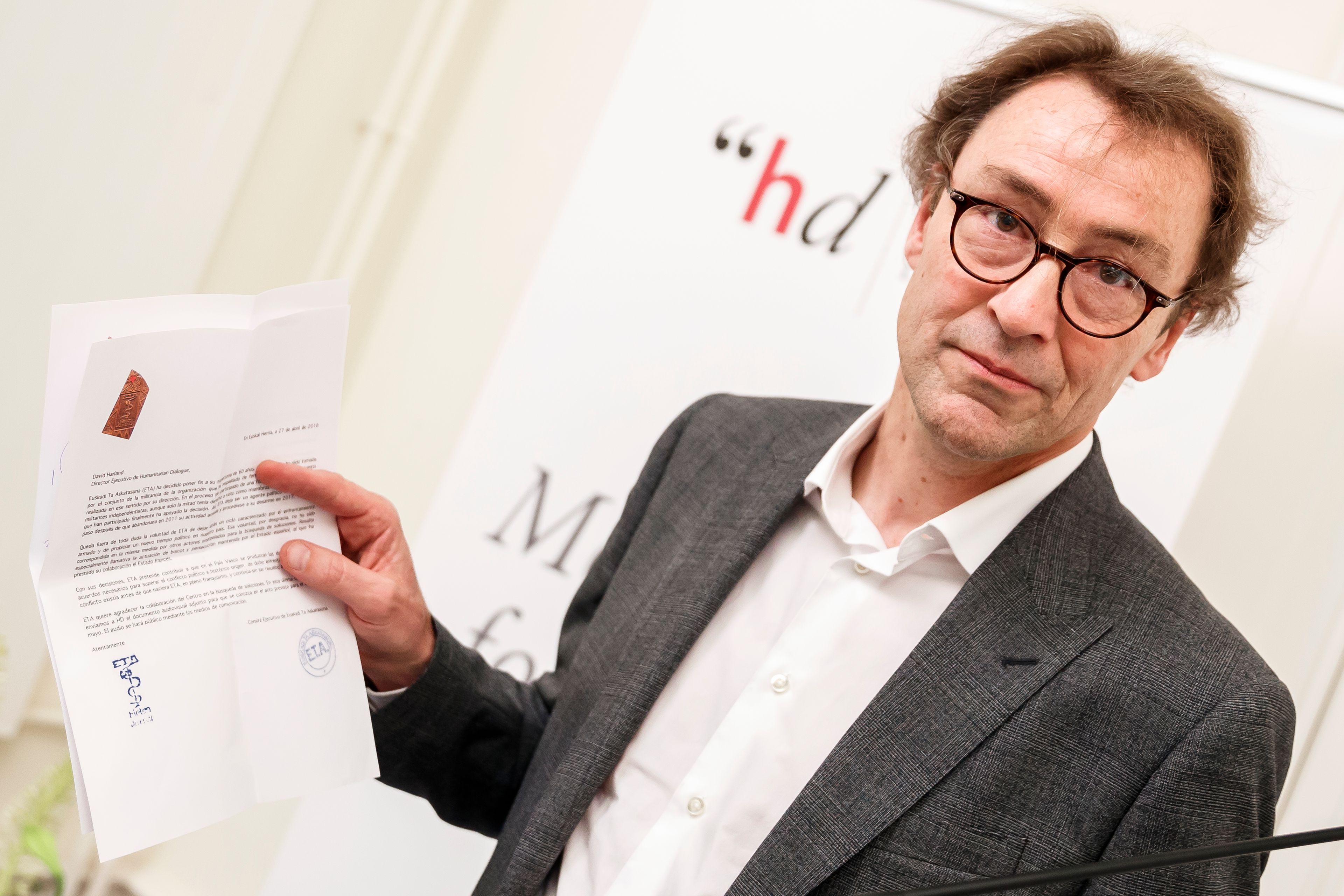 FILE - David Harland from New Zealand, Executive Director of the Centre for Humanitarian Dialogue (HD) holds a document at the Centre for Humanitarian Dialogue, in Geneva, Switzerland, Thursday, May 3, 2018. Russia's top state criminal investigation agency on Thursday, June 6, 2024, announced the arrest of a French citizen accused of collecting information on military issues. Russia's state news agency Tass identified the arrested French citizen as Laurent Vinatier, an employee of the Centre for Humanitarian Dialogue (HD), a Geneva-based nongovernment organization.