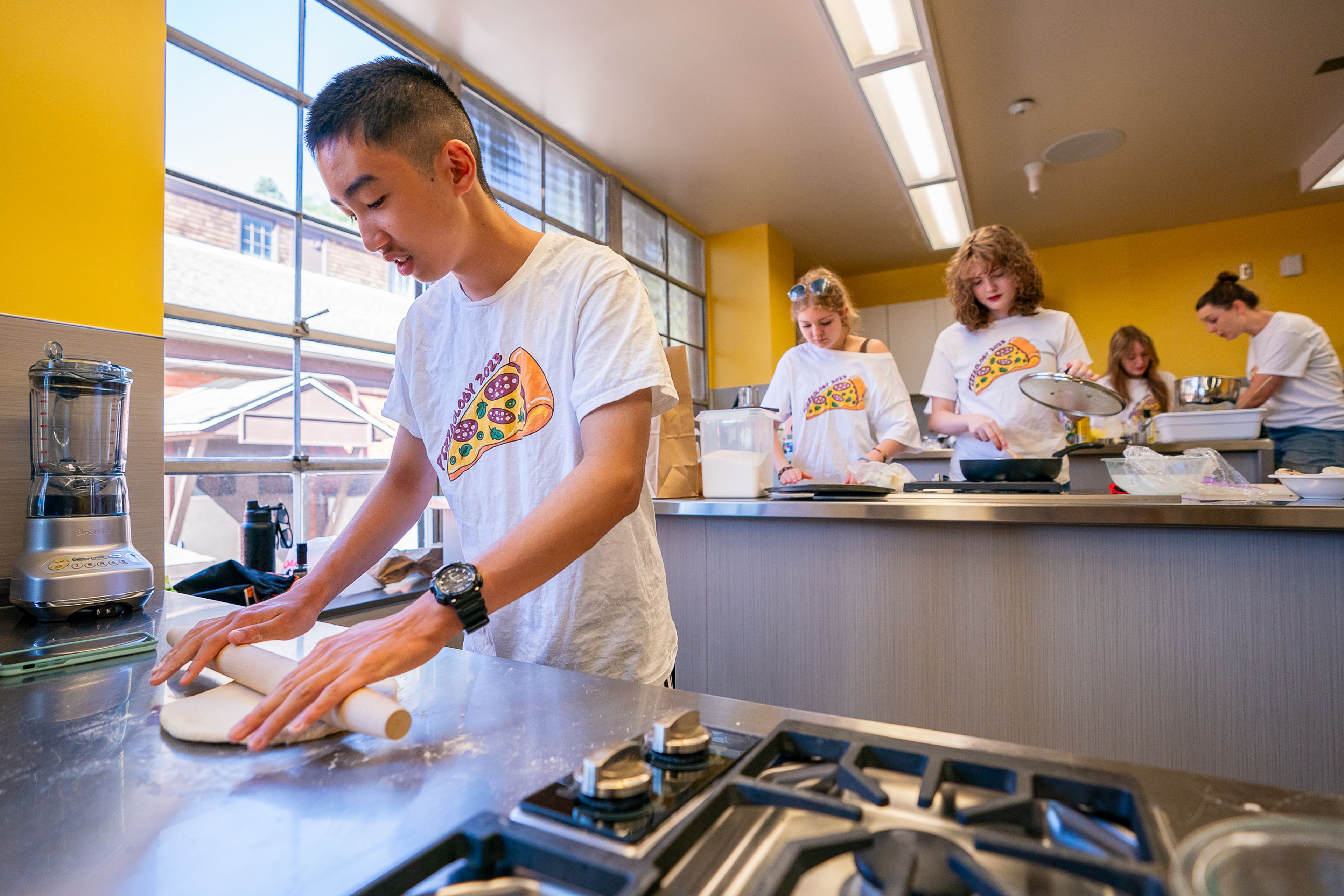 Kevin Ma, left, 15, of Moscow, rolls out his pizza dough during the final day of the 2023 Pizza-ology Camp on Wednesday at the Carmelita Spencer Food Laboratory in Moscow.