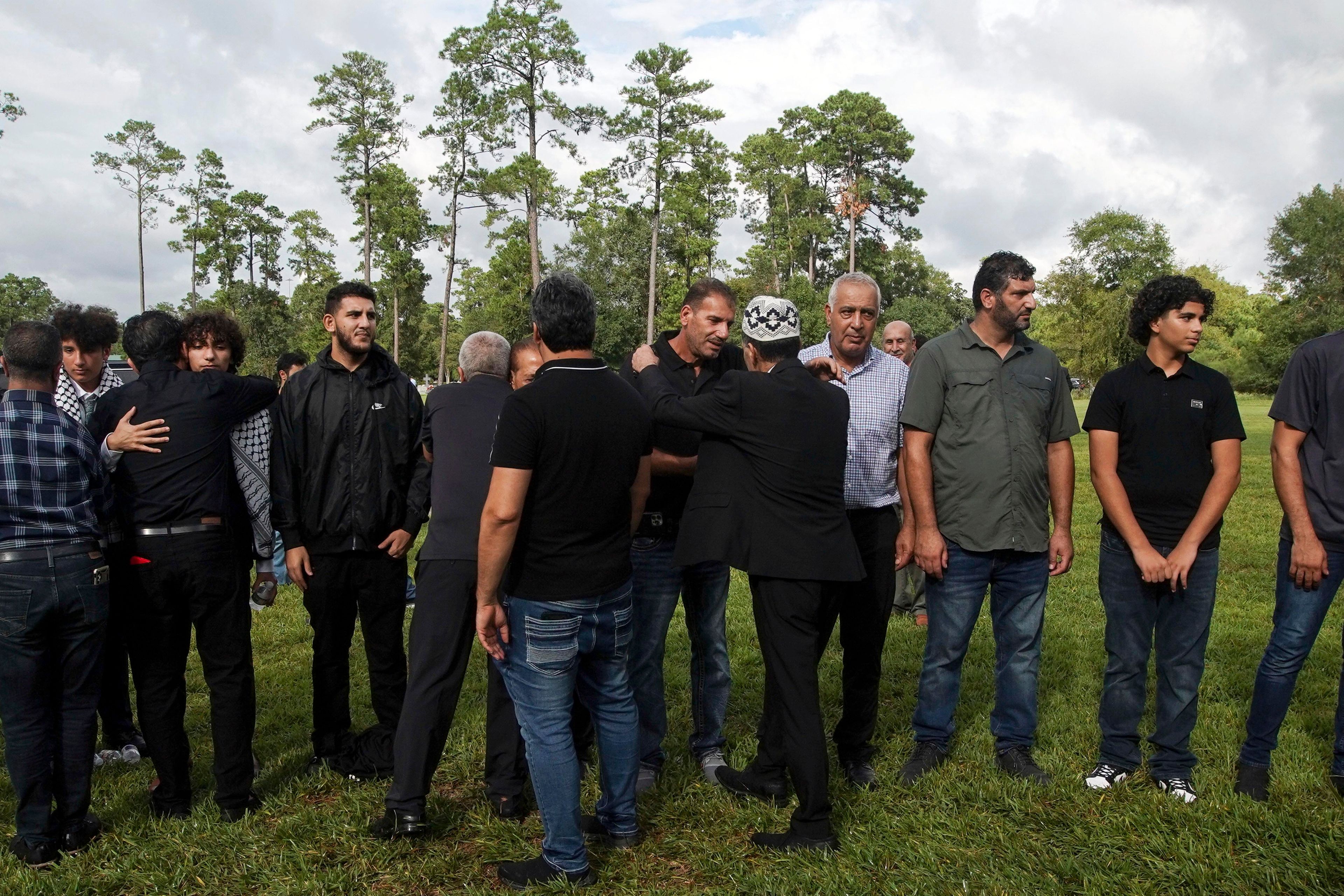 Friends and loved ones embrace after the burial of slain Harris County Precinct 4 Deputy Constable Maher Husseini on Thursday, Sept. 5, 2024, at Forest Park The Woodlands Funeral Home & Cemetery in The Woodlands, Texas.