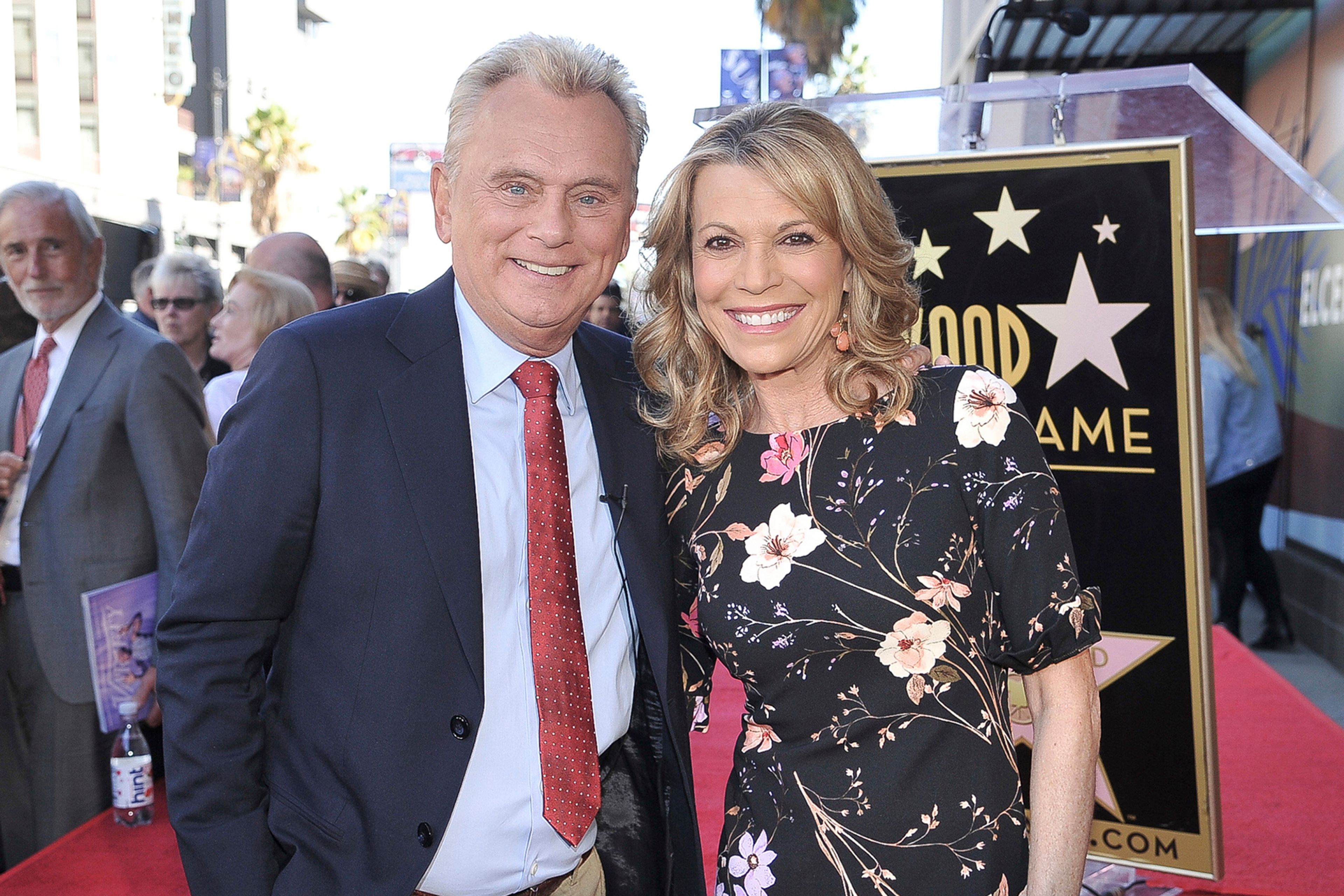 FILE - Pat Sajak, left, and Vanna White, from "Wheel of Fortune," attend a ceremony honoring Harry Friedman with a star on the Hollywood Walk of Fame in Los Angeles on Nov. 1, 2019.