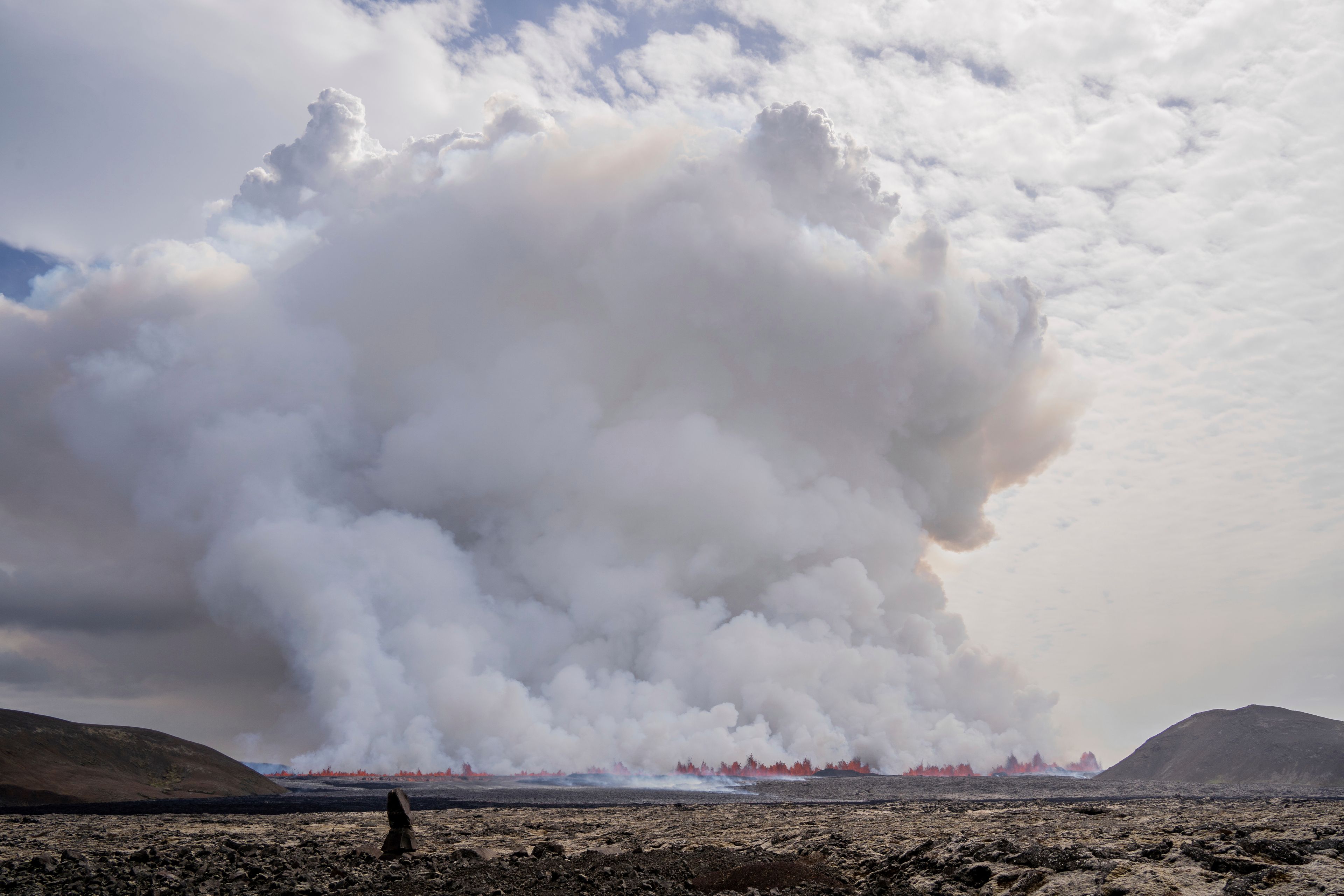 A cloud of smoke billows as a volcano erupts in Grindavik, Iceland, Wednesday, May 29, 2024. A volcano in southwestern Iceland is erupting, spewing red streams of lava in its latest display of nature's power. A series of earthquakes before the eruption Wednesday triggered the evacuation of the popular Blue Lagoon geothermal spa. The eruption began in the early afternoon north of Grindavik, a coastal town of 3,800 people that was also evacuated.