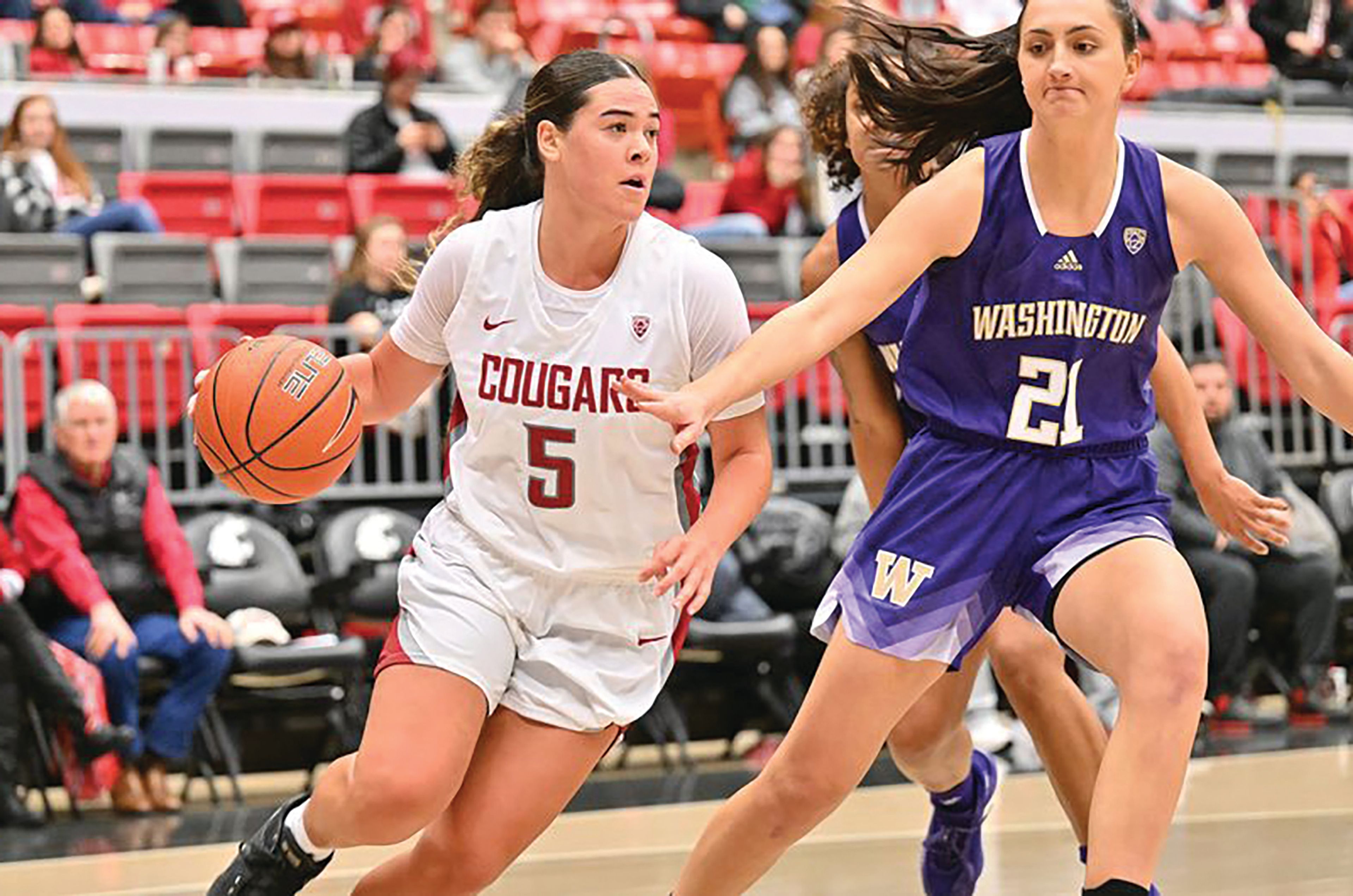 Washington State junior guard Charlisse Leger-Walker drives past Washington's Emma Grothaus during Sunday's Pac-12 Conference game at Beasley Coliseum. Leger-Walker finished with 26 points as the Cougars beat the Huskies.