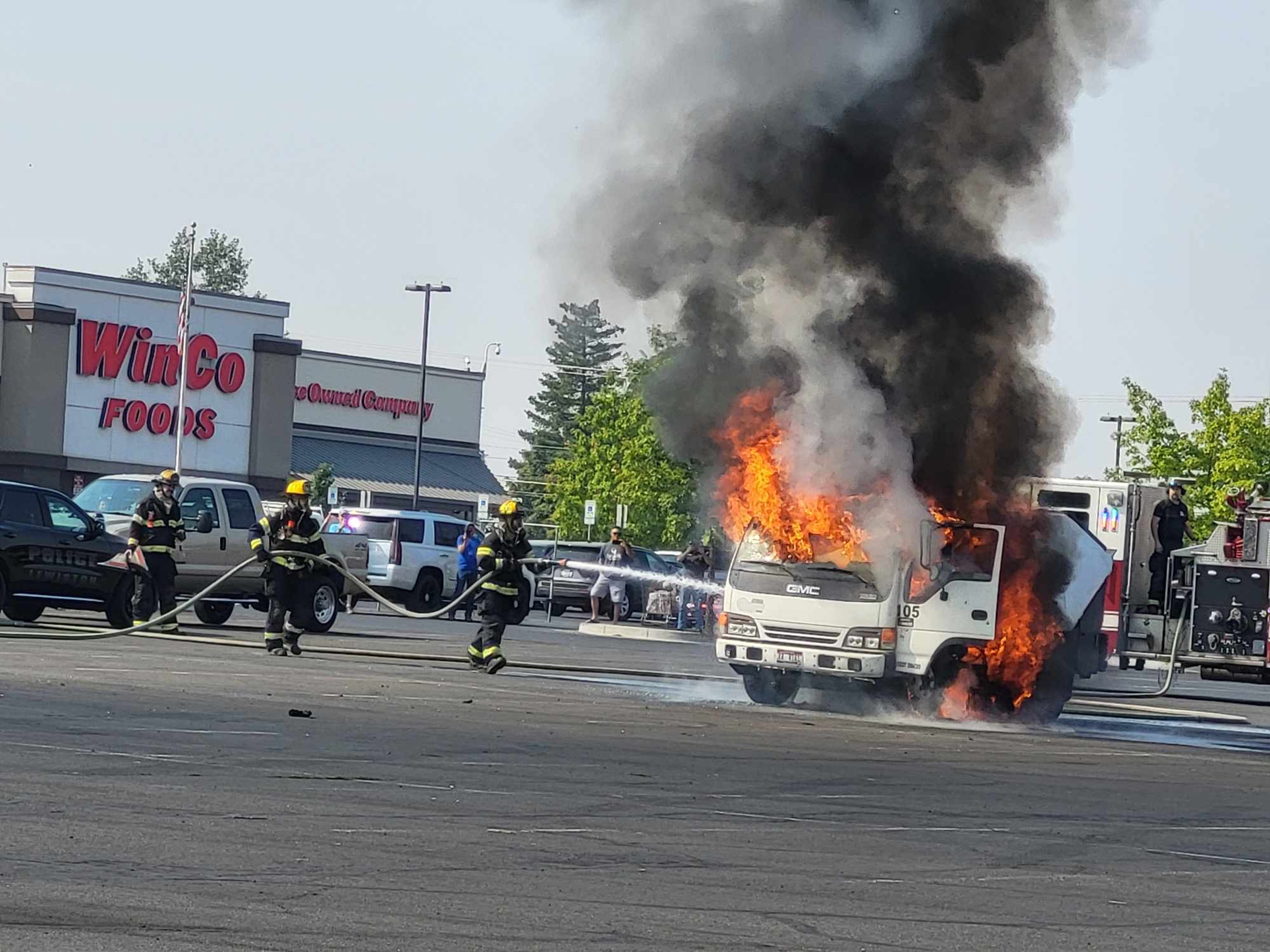 Firefighters work to put out a vehicle fire at the Lewiston Center Mall on Saturday morning.