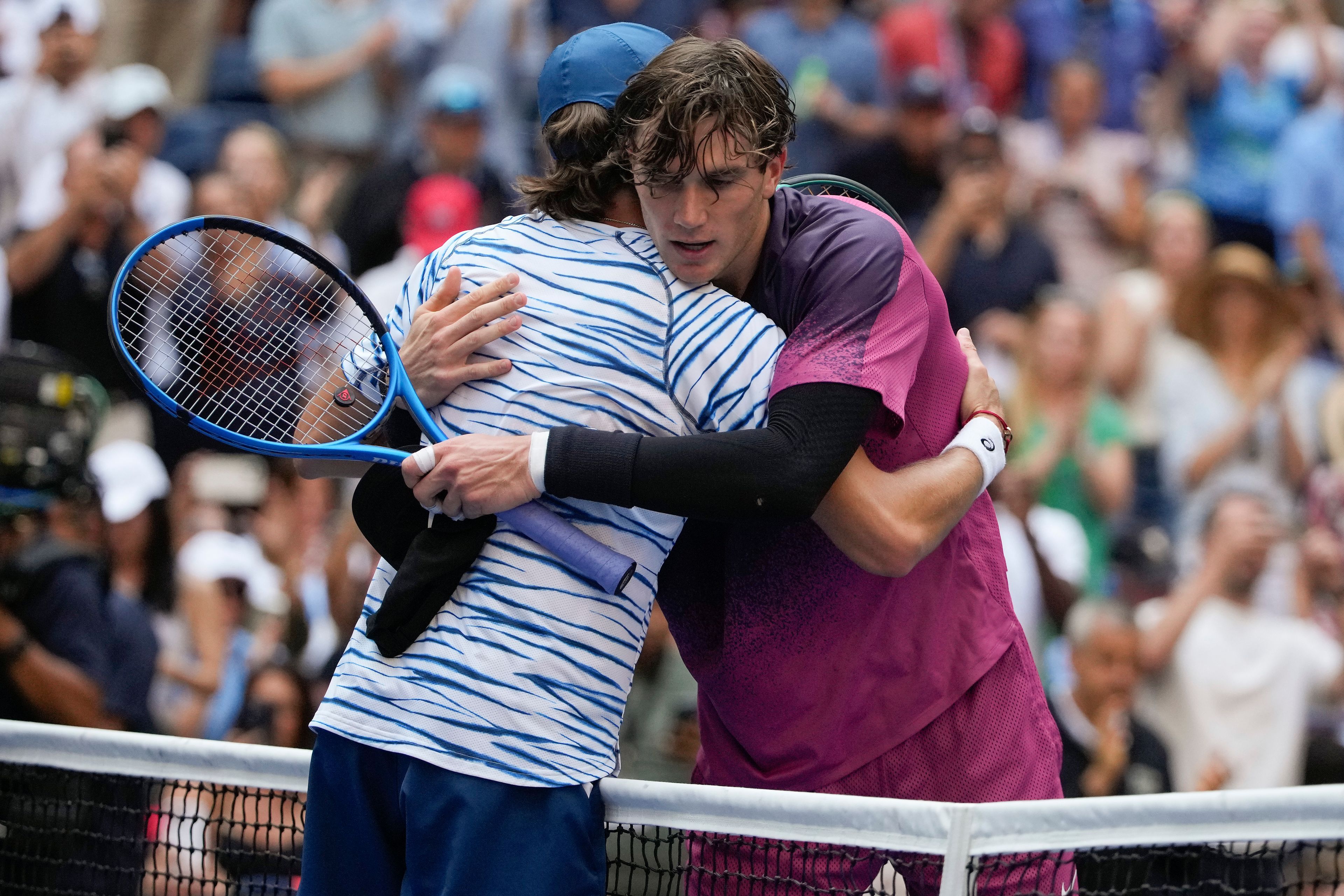 Jack Draper, of Great Britain, right, hugs Alex de Minaur, of Australia, after winning their quarterfinal match of the U.S. Open tennis championships, Wednesday, Sept. 4, 2024, in New York.