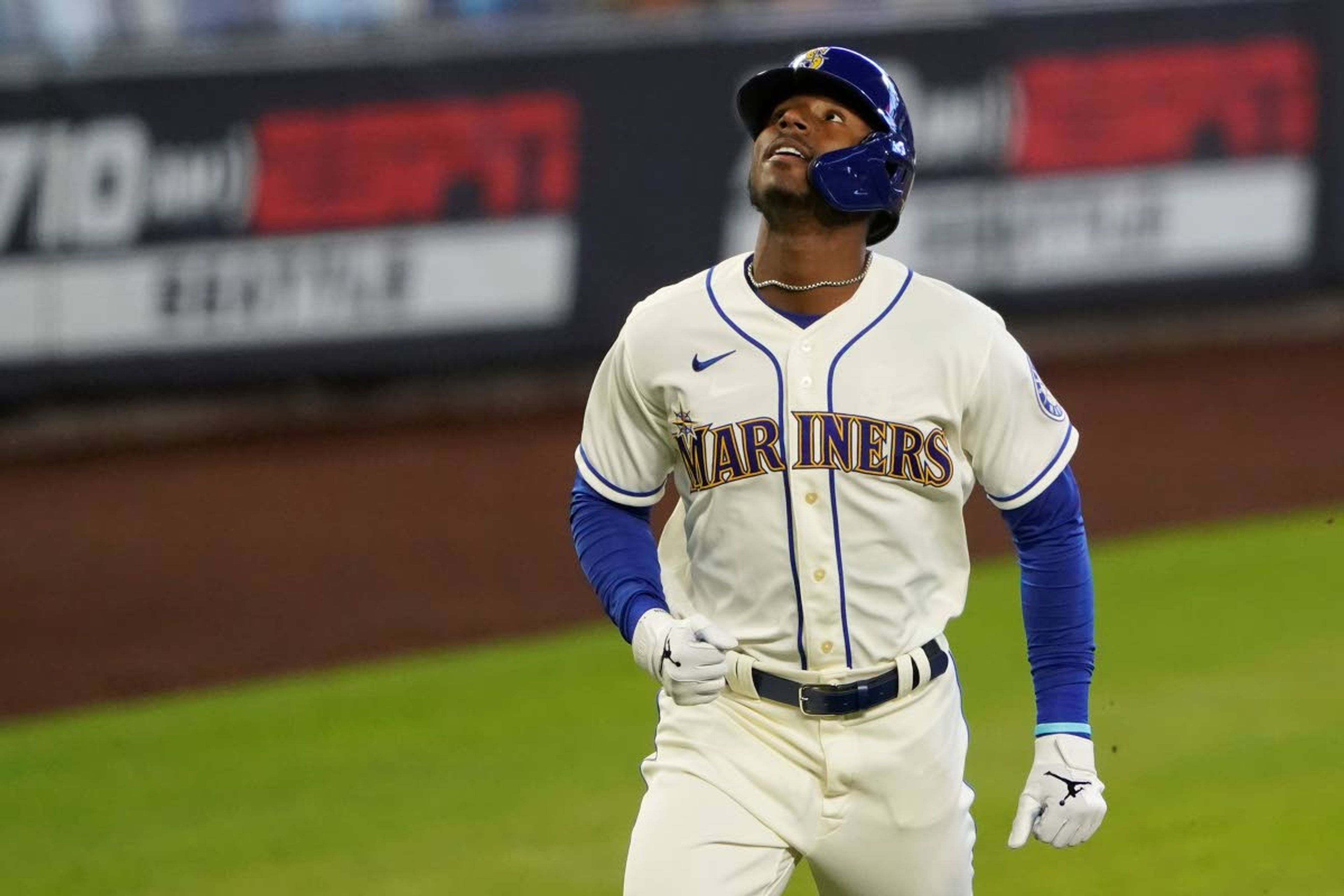 Seattle Mariners' Kyle Lewis looks up as he rounds the bases after hitting a solo home run against the Texas Rangers during the first inning of a baseball game, Sunday, Aug. 23, 2020, in Seattle. (AP Photo/Ted S. Warren)