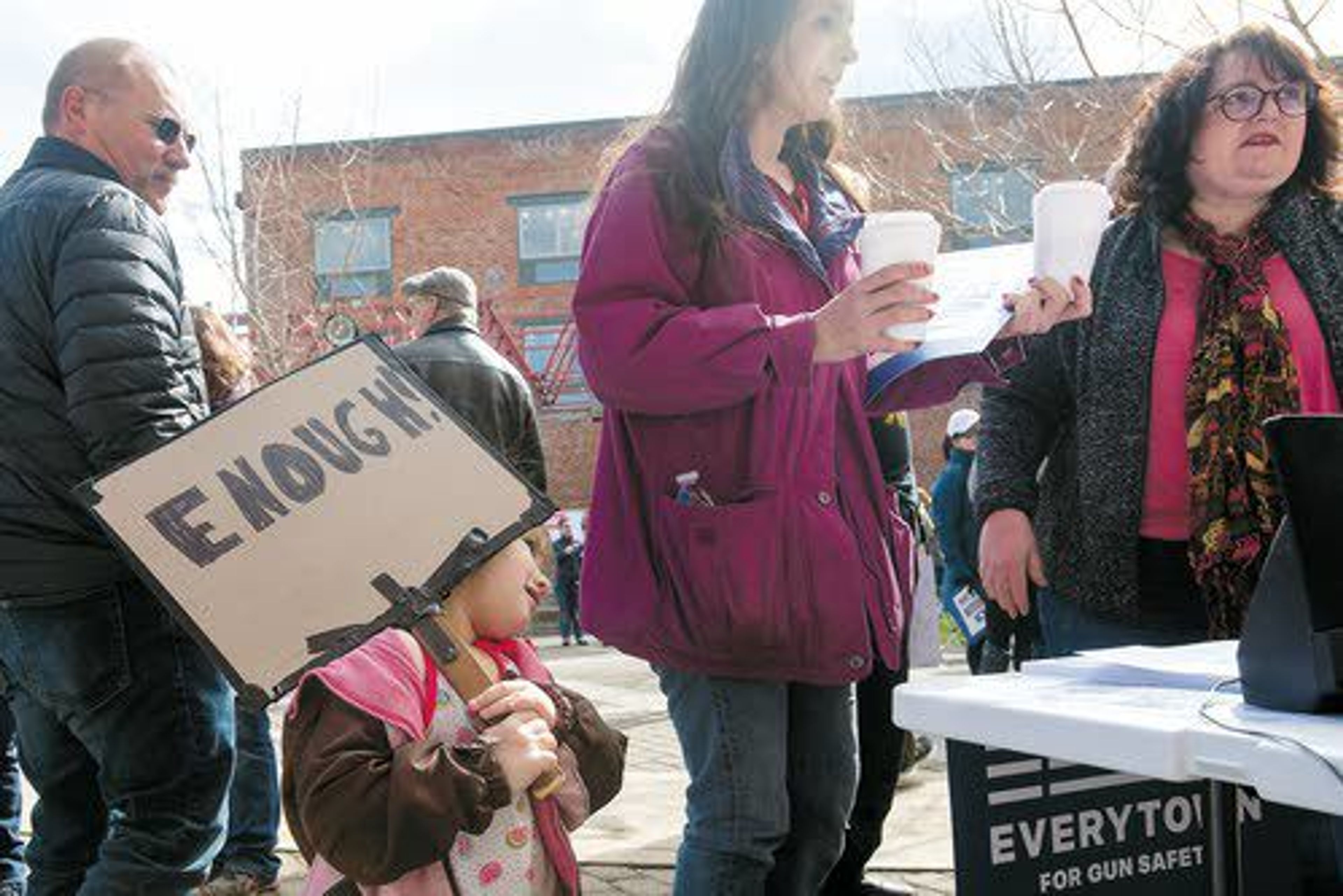 Sammi Betts, 4, of Clarkston, holds a sign while standing next to her mother, Julie Peterson, right-center, at the tail end of the March for Our Lives Rally in Lewiston on Saturday.