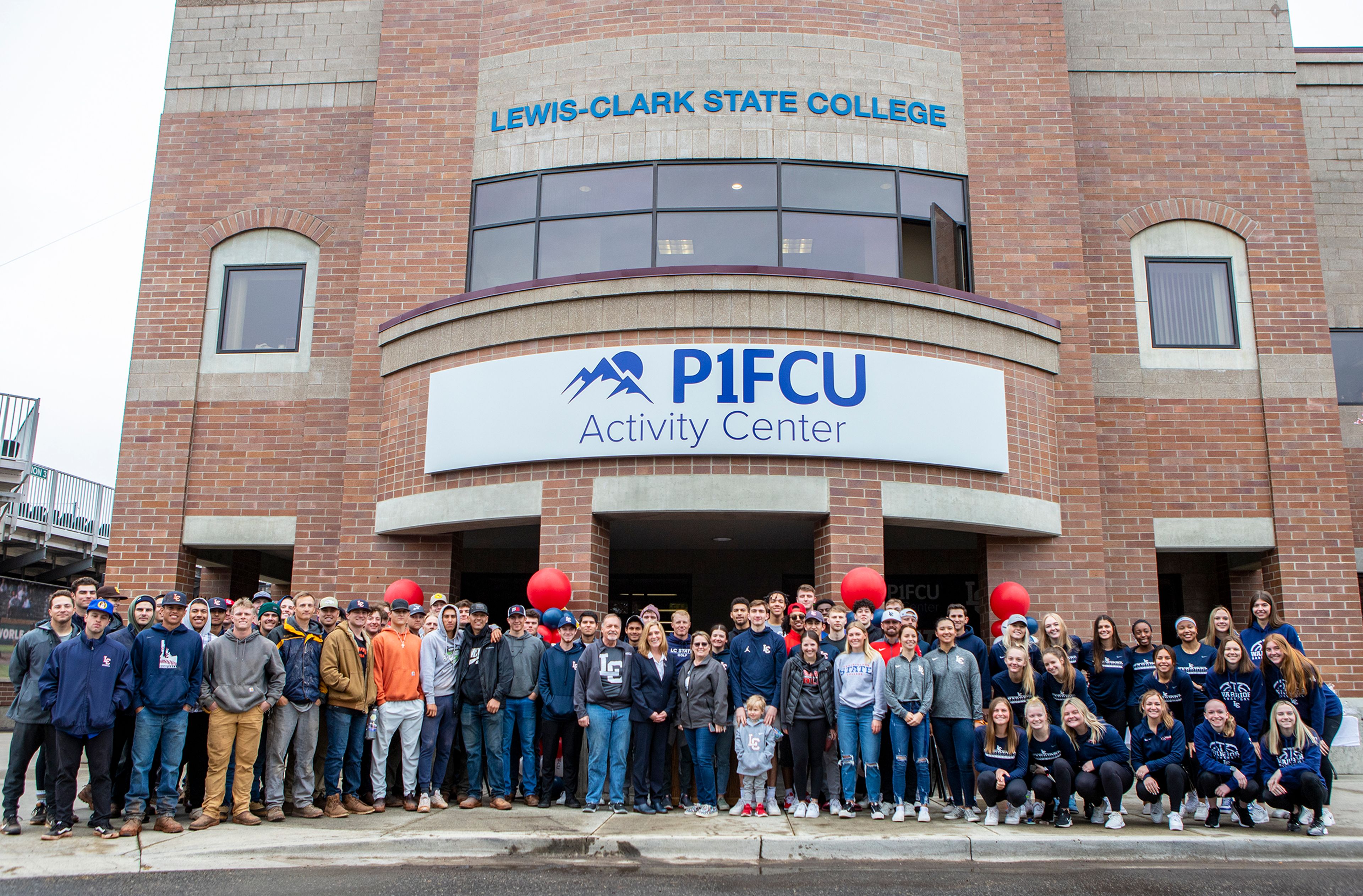 Lewis-Clark State College athletes, staff and administrators along with friends and family pose for a group photo at the P1FCU Activity Center’s naming ceremony in Lewiston on Saturday.