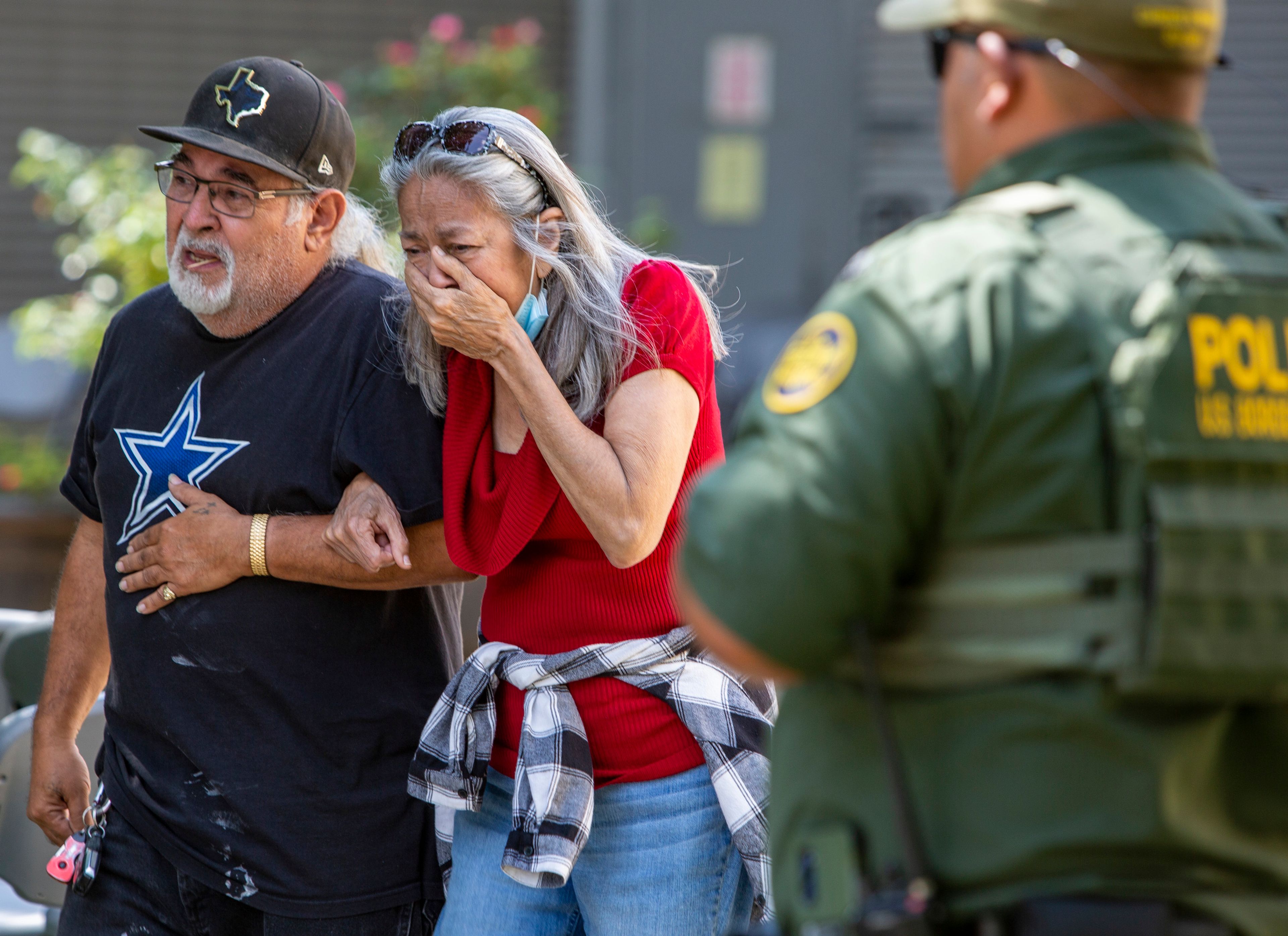 A woman cries Tuesday as she leaves the Uvalde Civic Center, in Uvalde, Texas.