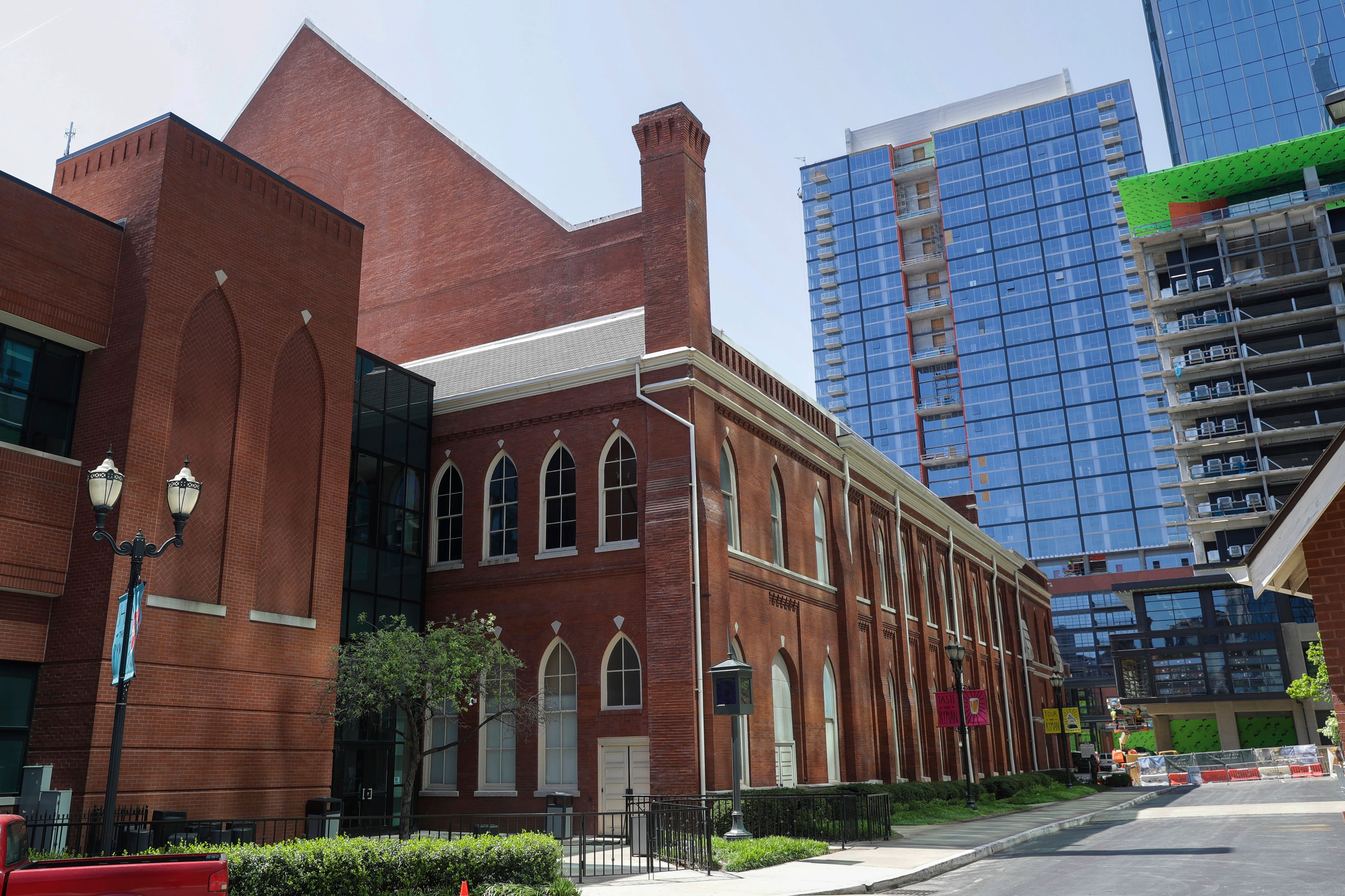 FILE - The Ryman Auditorium is surrounded by newer buildings in Nashville, Tenn., on April 16, 2020.