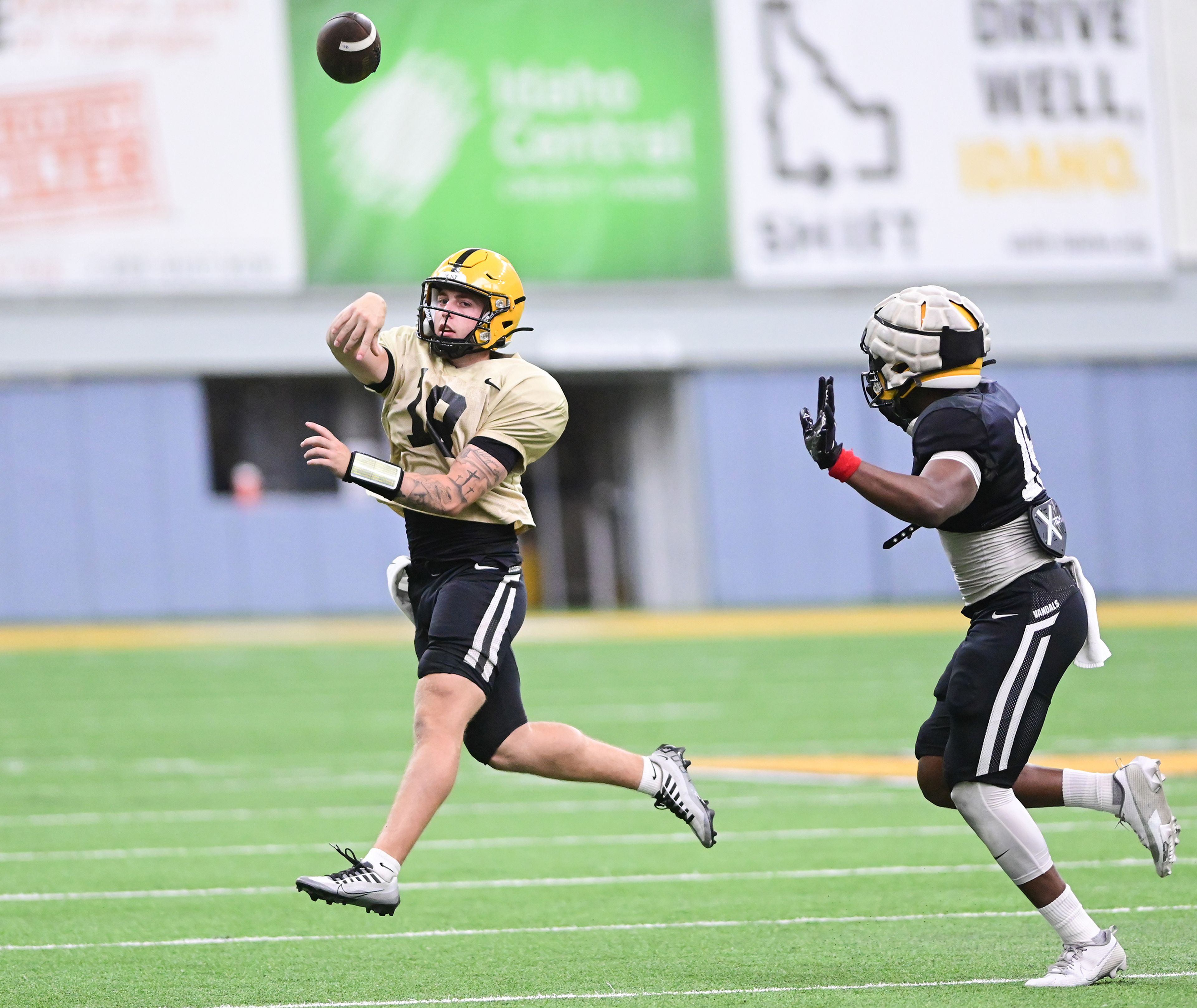 Idaho quarterback Nick Josifek makes a pass while running down the field at the team�s first fall camp scrimmage on Aug. 8 in Moscow.