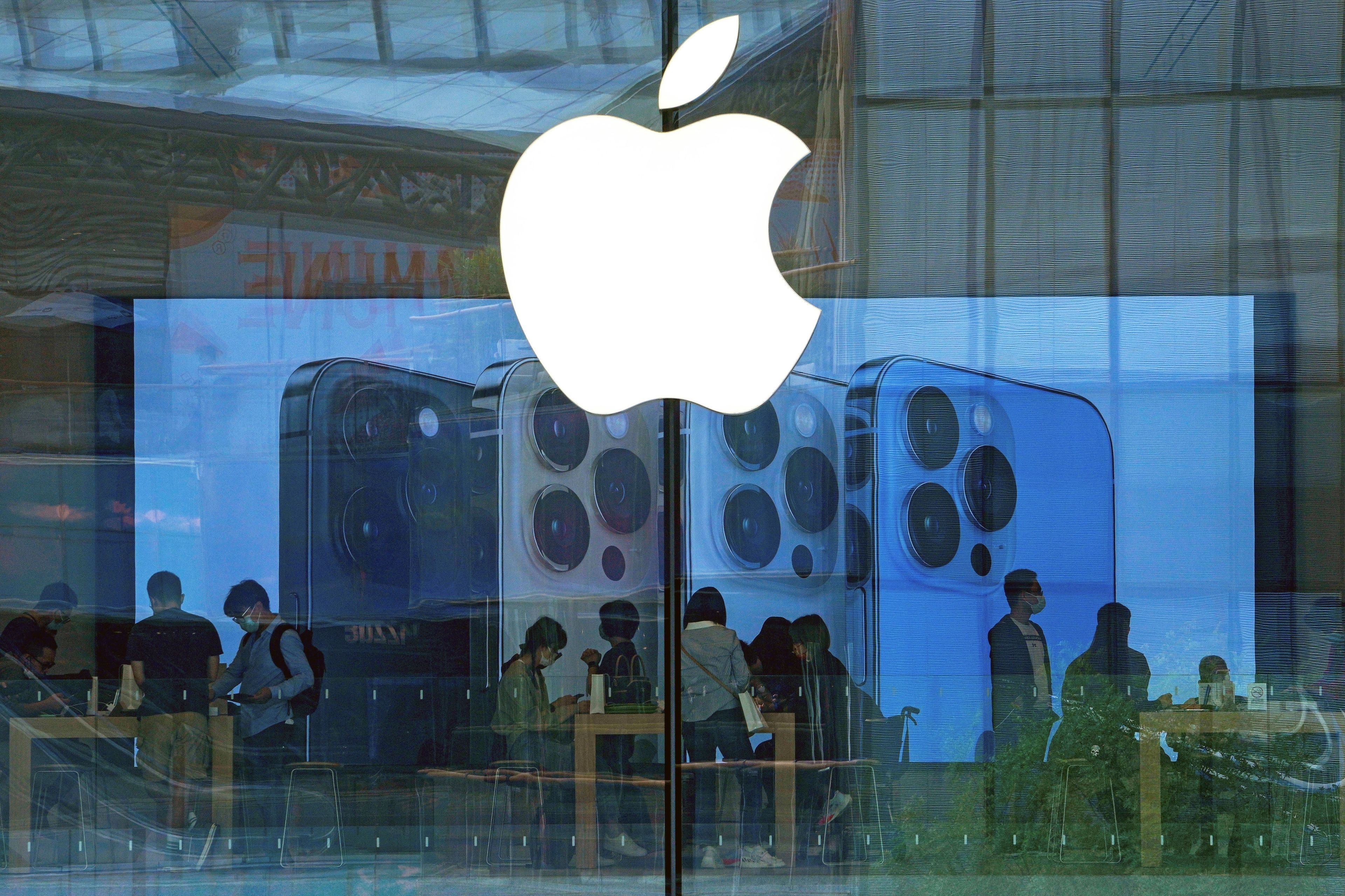 FILE - People try out iPhone products at an Apple Store in Beijing, Sept. 28, 2021. A federal judge on Wednesday questioned whether Apple has set up a gauntlet of exasperating hurdles to discourage the use of alternative payment options in iPhone apps, despite a court order seeking to create more ways for consumers to pay for digital services.