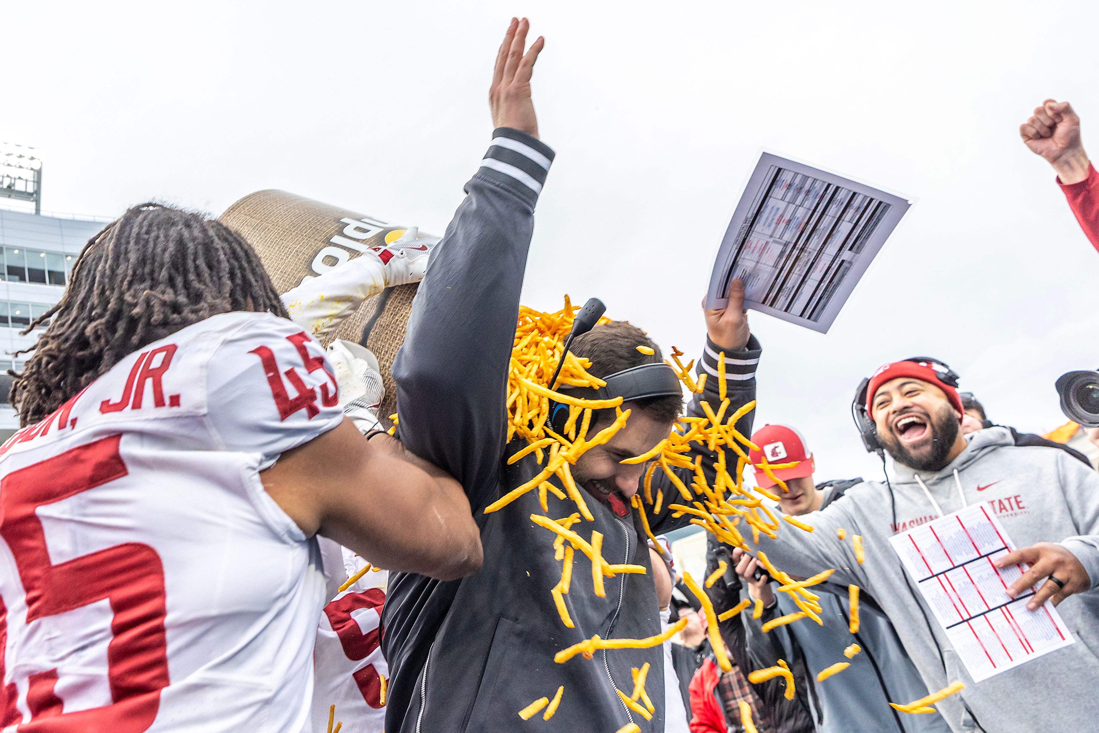Washington State interim coach Jesse Bobbit is covered in French fries after the Cougars defeated Utah State 34-21 during the Famous Idaho Potato Bowl on Monday at Albertsons Stadium in Boise.